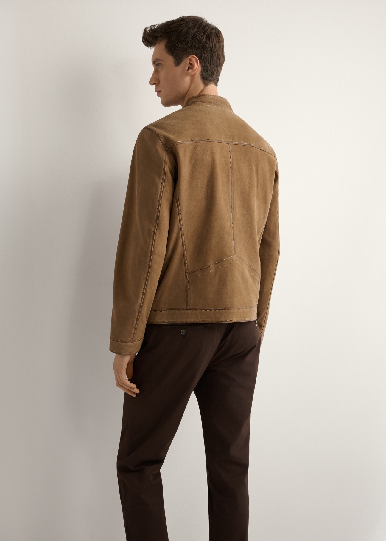 Men's dark beige suede jacket KURMS-0398-1C(W26) - back view of the product, on a model, against a light background. Knee-length silhouette visible.