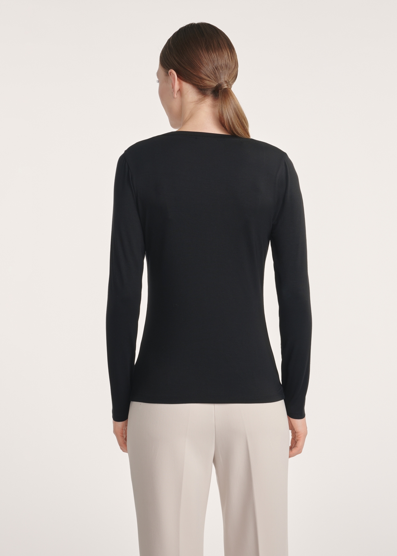 Black women's blouse LSLDT-0055-99(Z25), product visible from the back on the model, half of the silhouette visible.