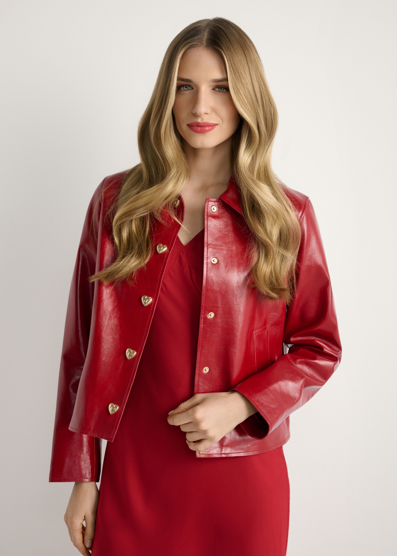 Red short women's jacket KURDS-0612-4B(W26), product view from the front on the model, half of the silhouette visible.