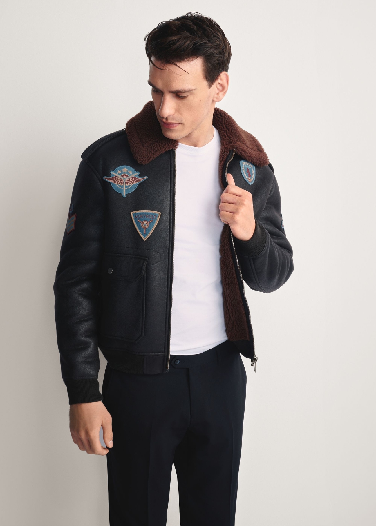 Men's brown aviator-style sheepskin coat KOZMP-0007-1I(Z26) - front view of the product modeled against a white background. Knee-length silhouette visible.