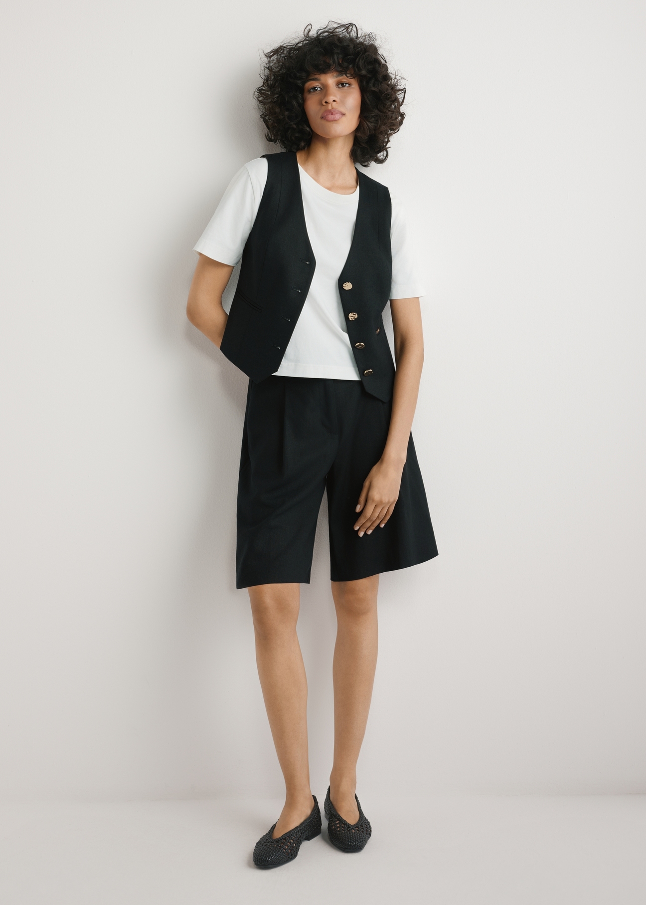 Women's elegant black shorts SZODT-0017-99(W26), front view of the product on the model. Full body visible.