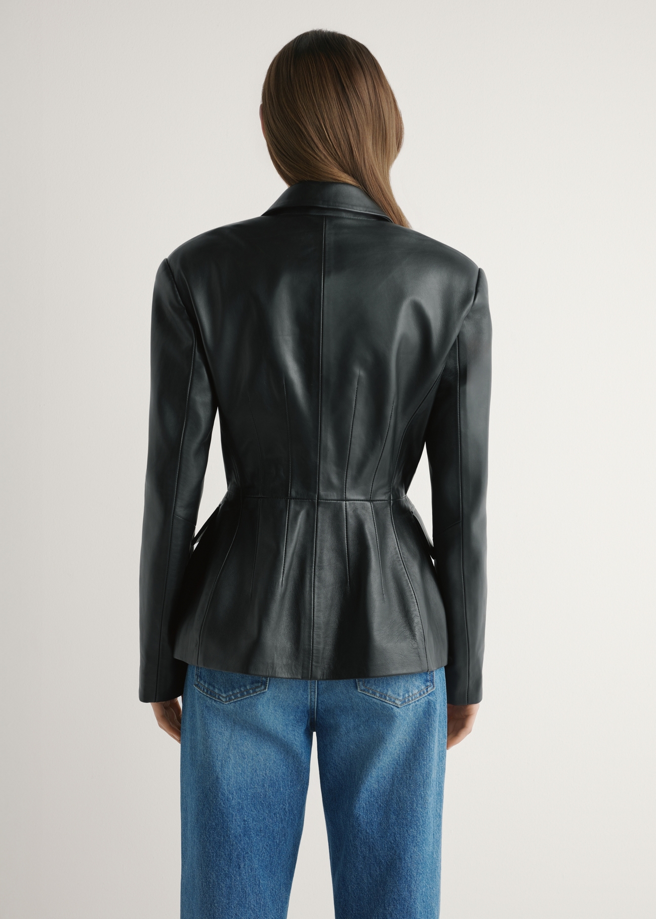 Women's black leather jacket KURDS-0600-99(W26) - back view of the product on a model, on a light background.