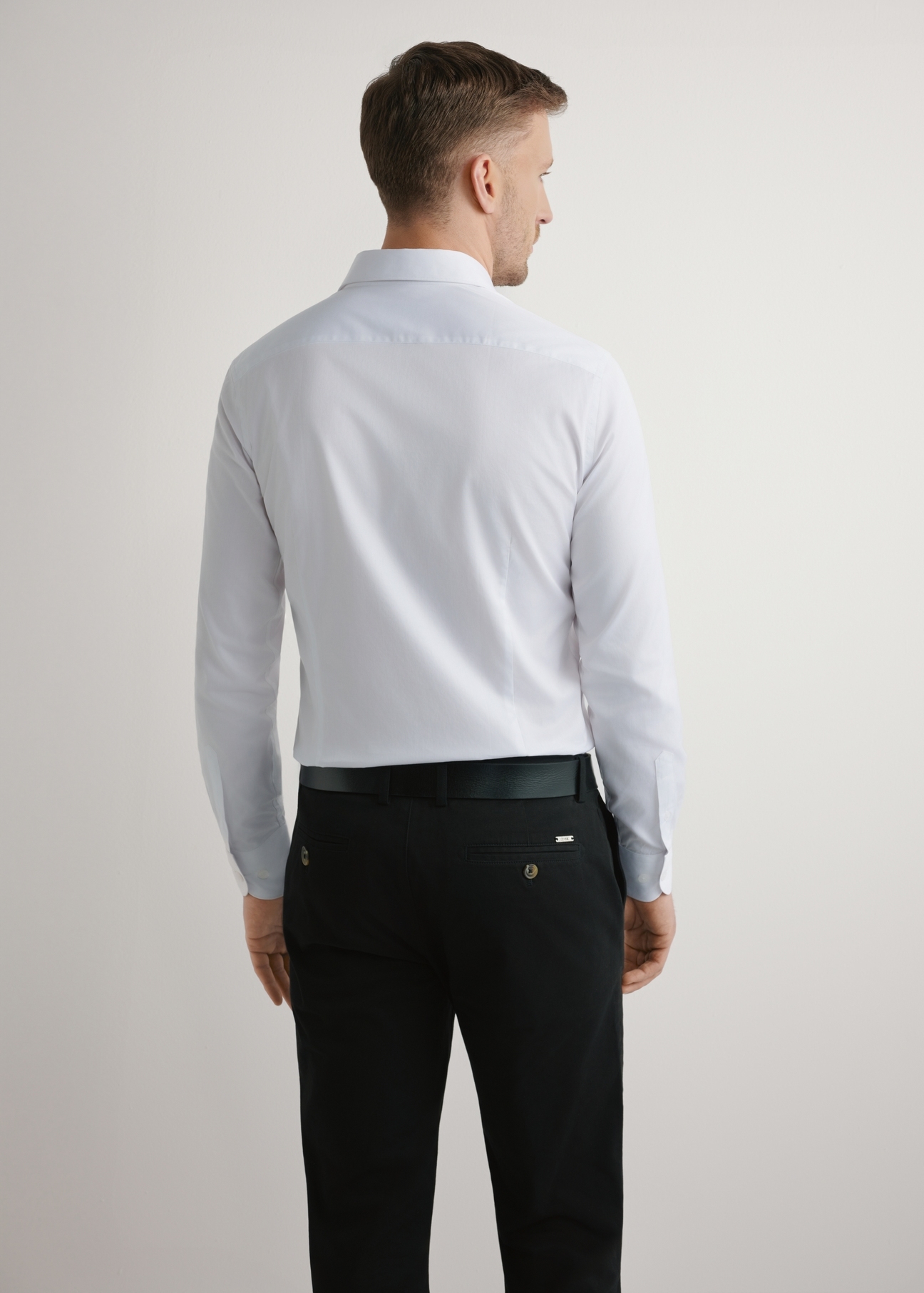 White men's slim shirt KOSMT-0352-0A(W26), back view of the product on the model. Half of the silhouette visible.