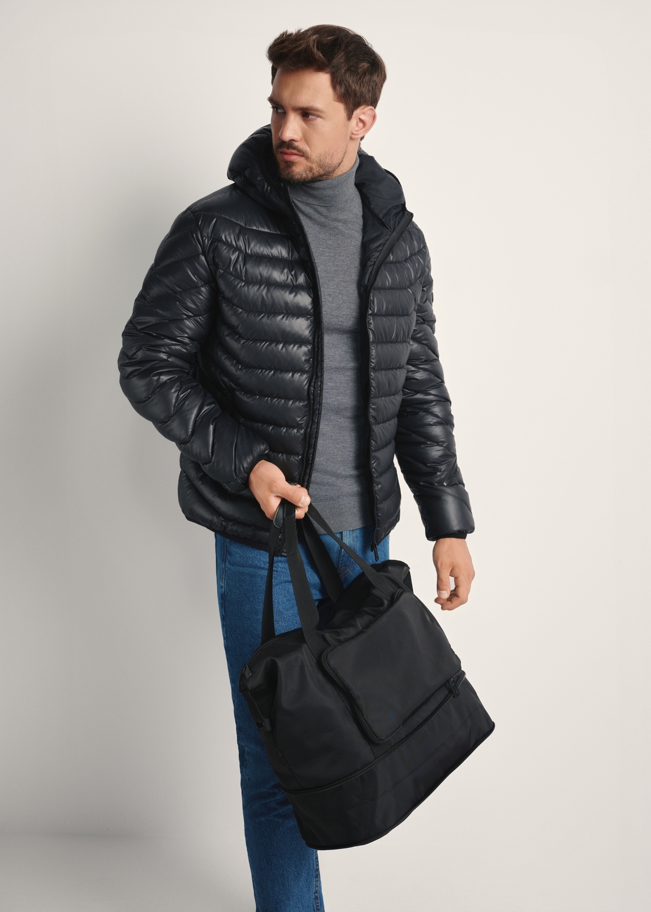 Black men's bag TORMN-0369-99(Z25), diagonal view of the product on the model, half of the silhouette visible.