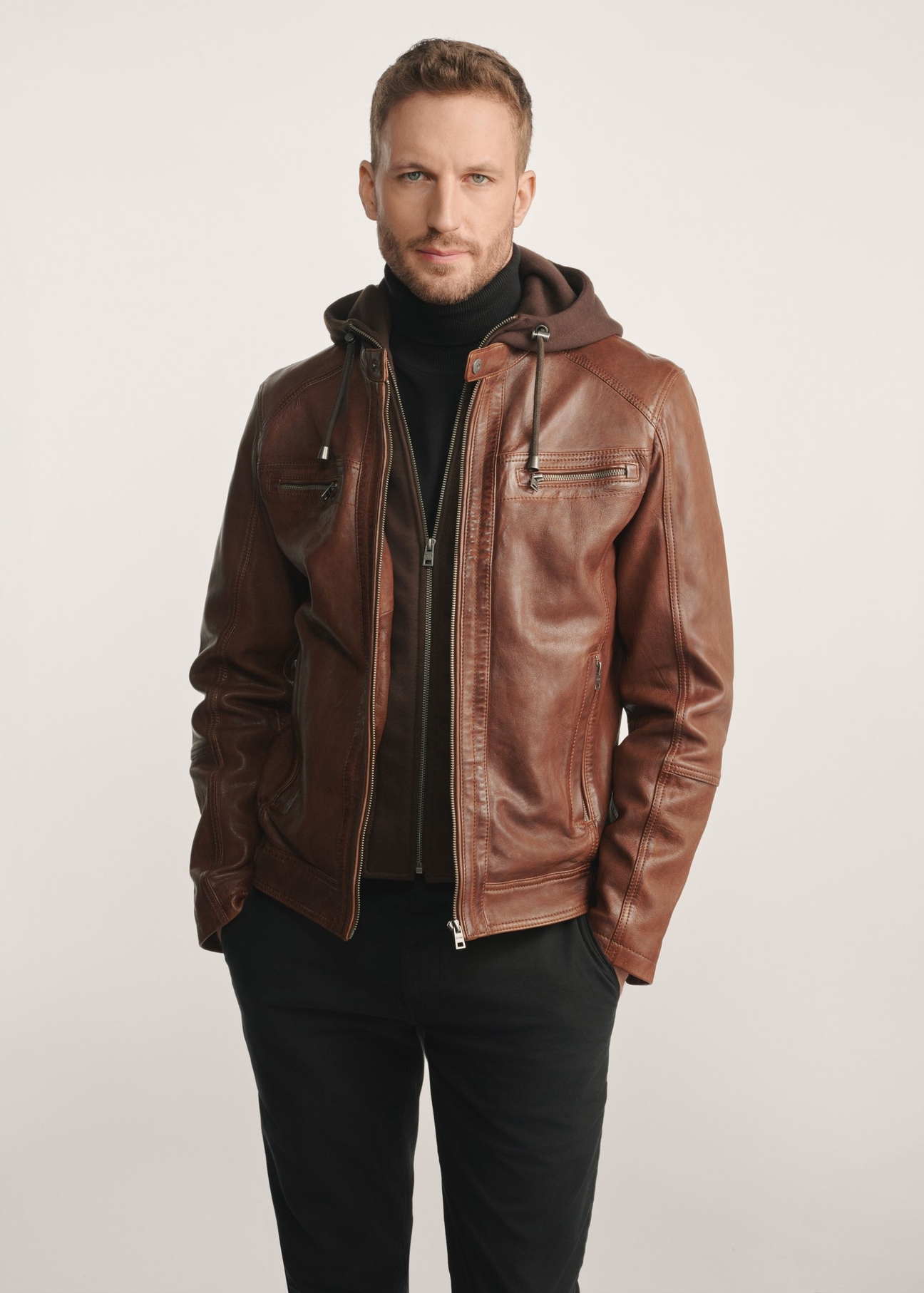 Brown men's leather jacket with hood KURMS-0385-2875(Z25), product view from the front on the model, half of the silhouette visible.