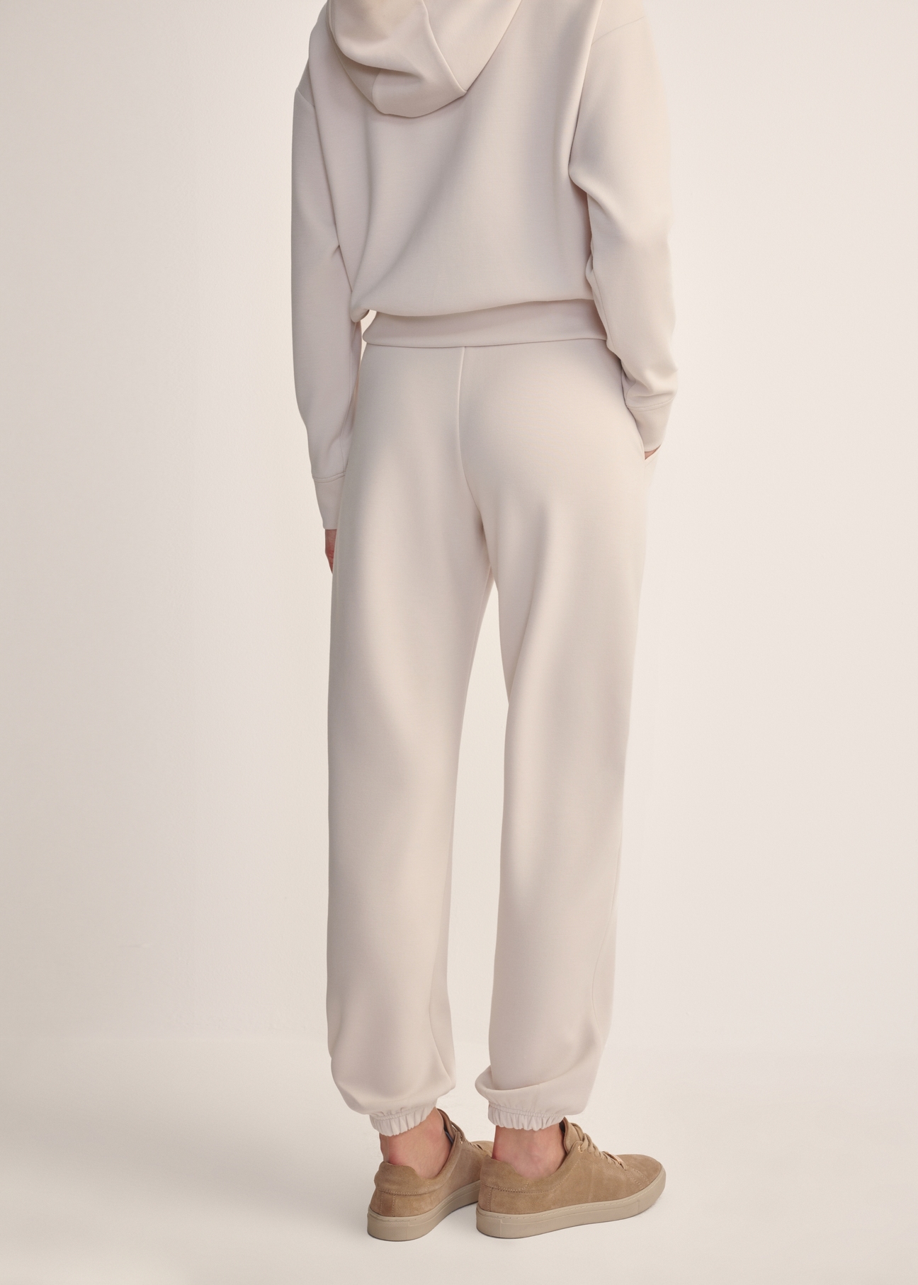 Light beige women's trousers SPODT-0117-80(Z25), back view of the product on the model. Half of the silhouette visible.
