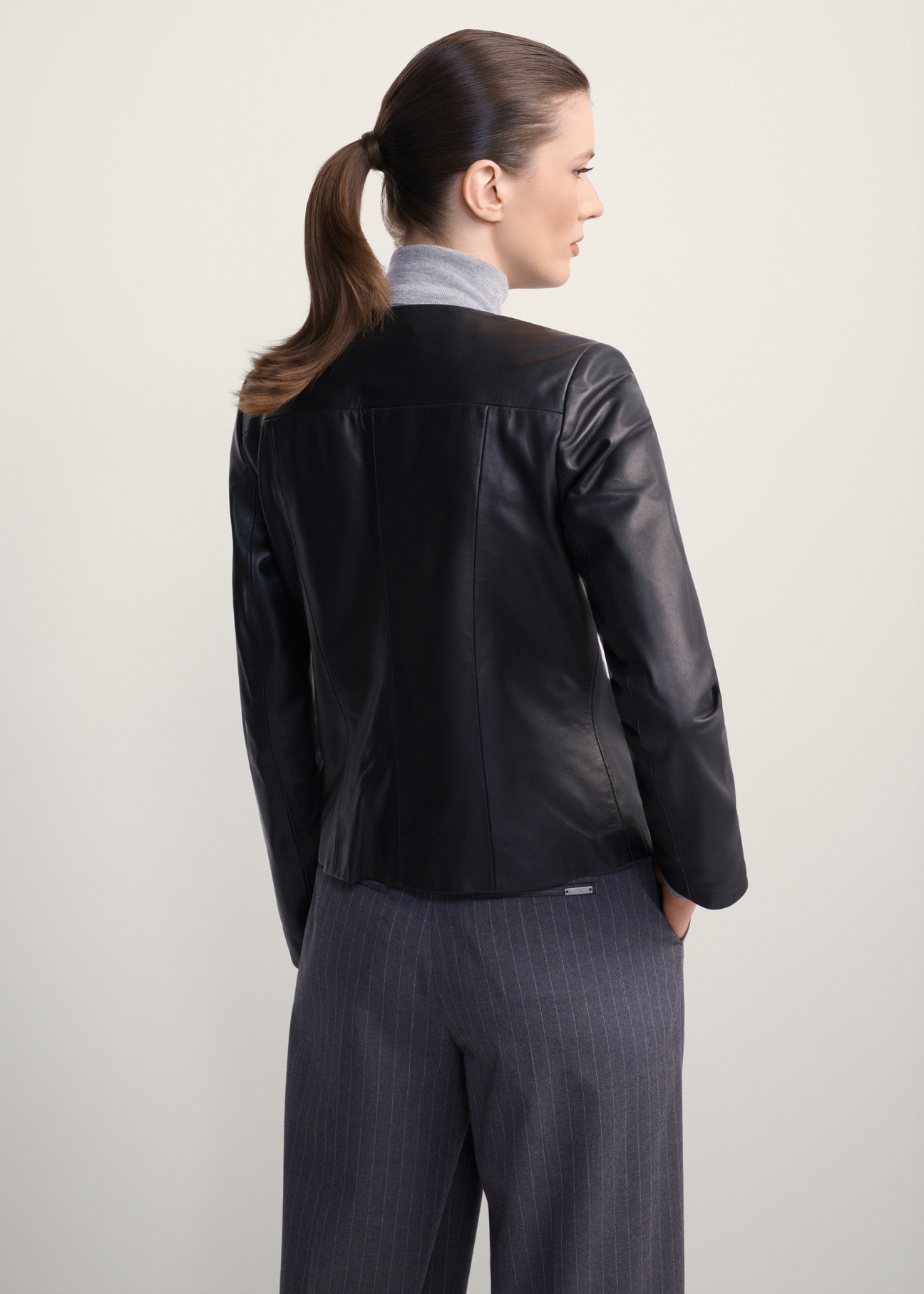 Classic women's genuine leather jacket KURDS-0209-1339(KS), back view of the product on the model. Half of the silhouette visible.