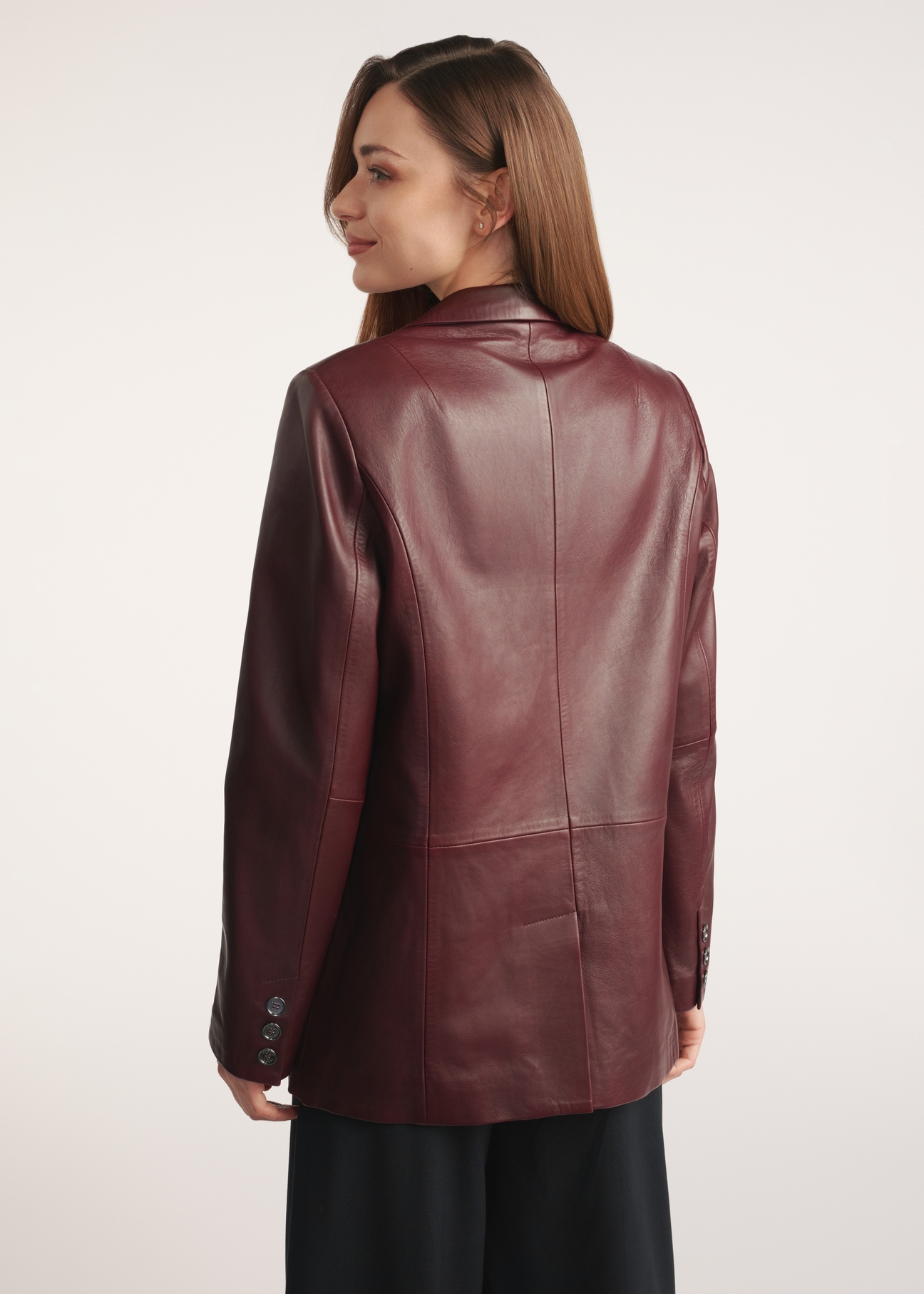 Burgundy women's leather jacket KURDS-0556-2869(Z25), product view from the back on the model, half of the silhouette visible.