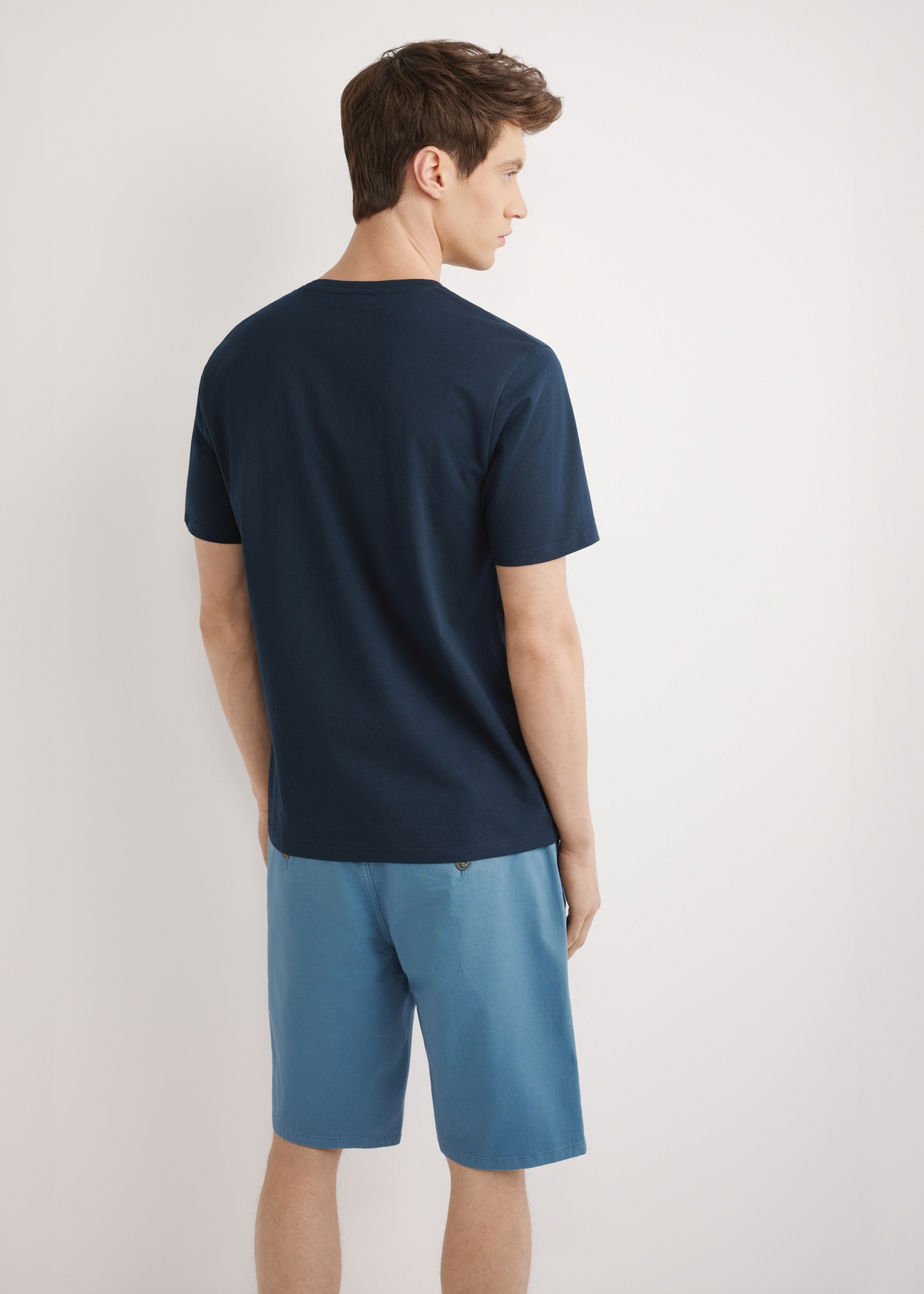 Navy blue men's T-shirt with print TSHMT-0147-7E(W26), back view of the product, on a model, against a light background. Half of the silhouette visible.