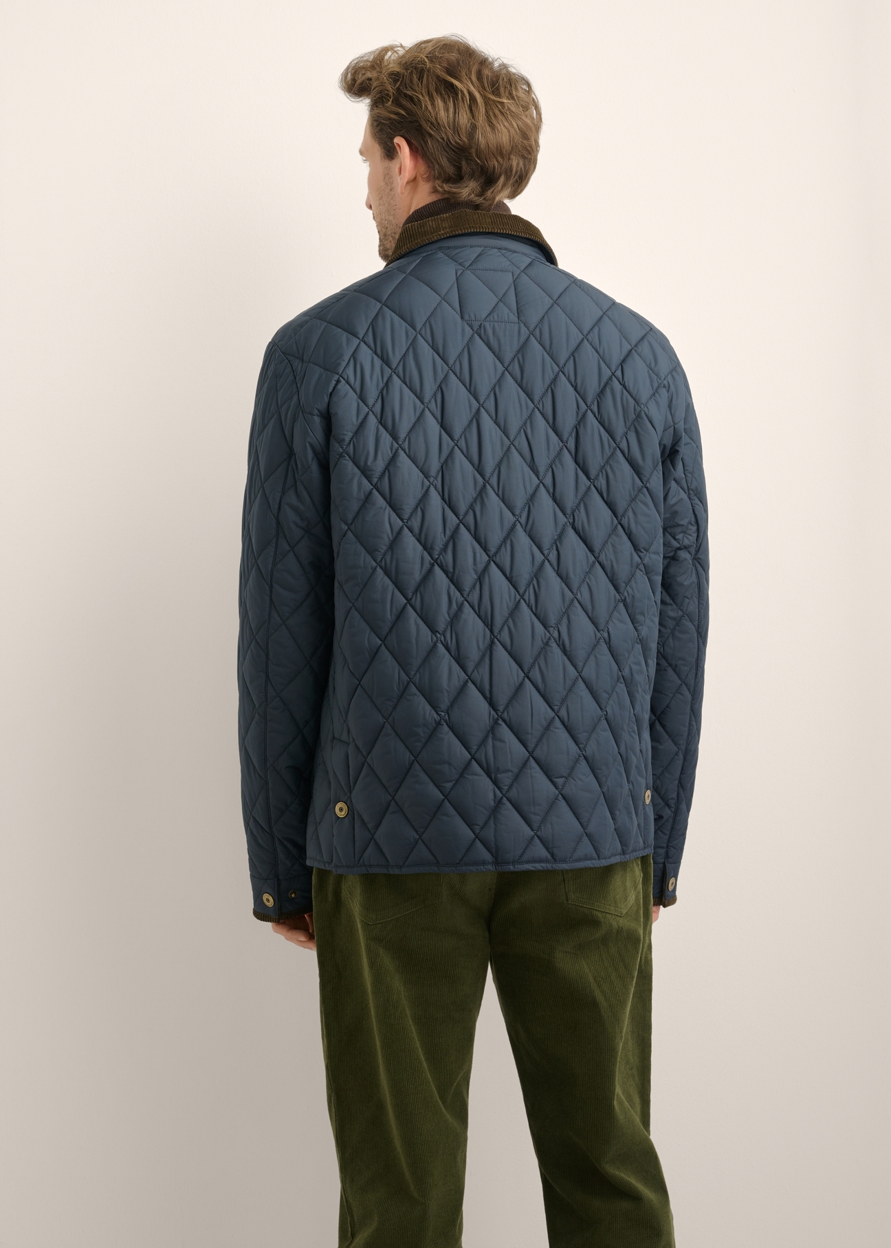 Men's navy blue quilted jacket KURMT-0427-7E(Z26), product view from the back on the model. Half of the silhouette visible.