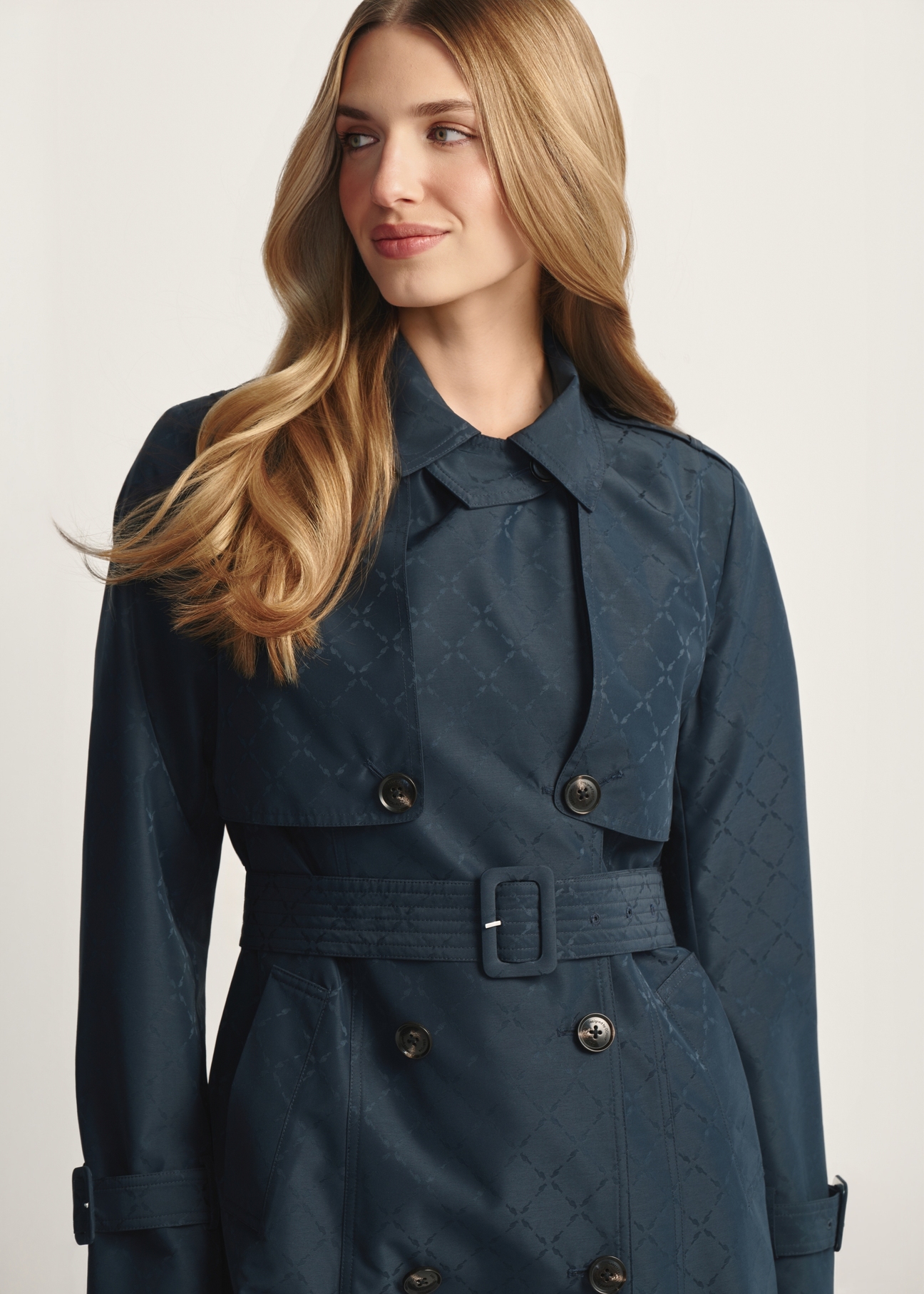 Navy blue women's coat with monogram KURDT-0651-7E(W26), front view of the product on the model. Half of the silhouette visible.