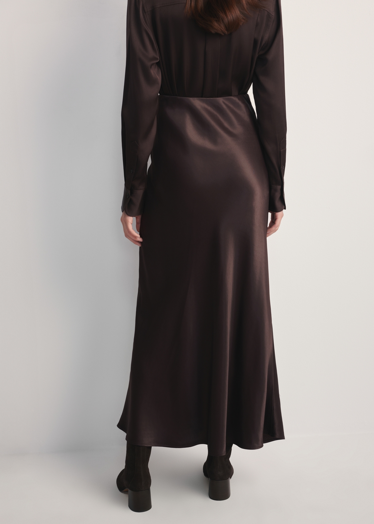 Chocolate long women's skirt SPCDT-0117-90(Z25), back view of the product on the model. Half of the silhouette visible.