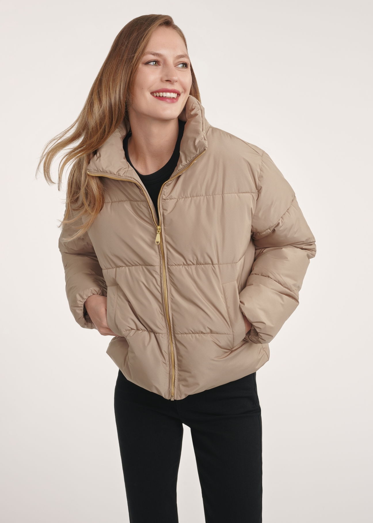 Short beige women's jacket KURDT-0601-24(Z25), front view of the product on the model. Half of the silhouette visible.