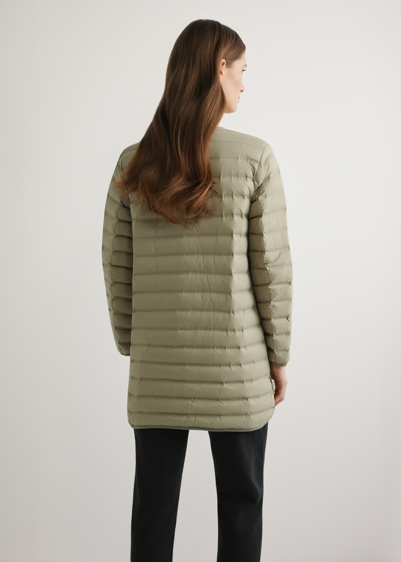 Women's olive green jacket with natural insulation KURDT-0636-8E(W26) - product view from the back, on a model, against a light background. Half-length silhouette visible.