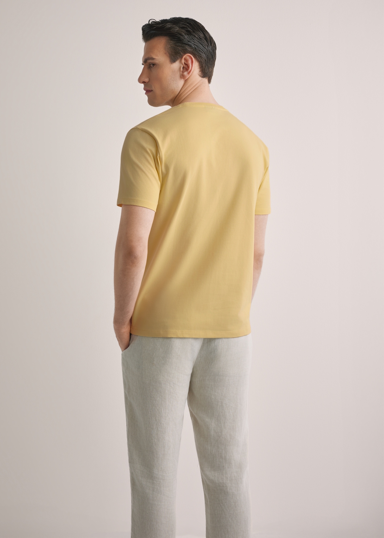 Men's yellow T-shirt TSHMT-0120-2B(W26), back view of the product on the model. Half of the silhouette visible.