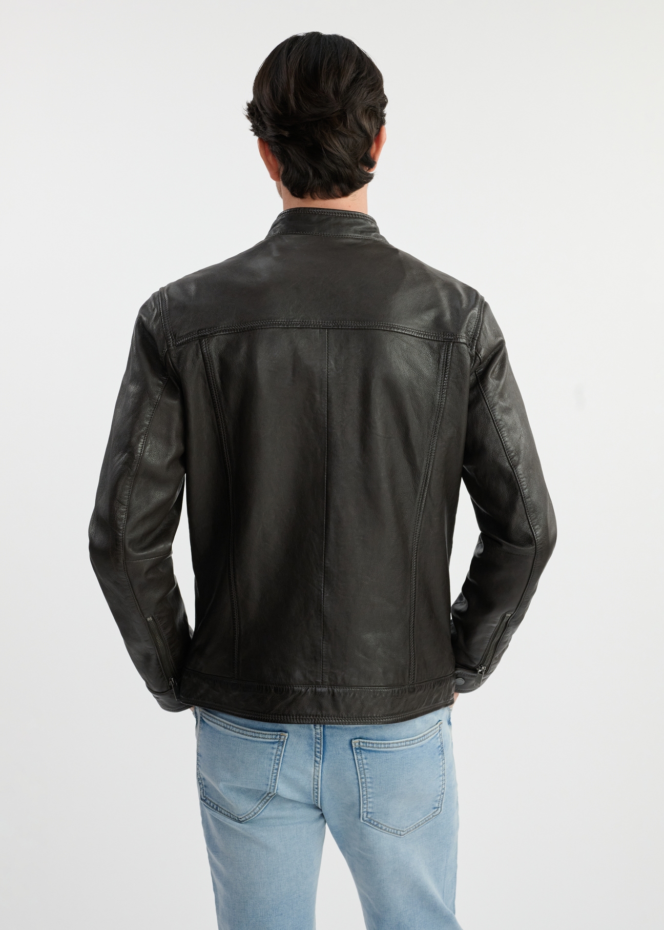 Dark brown men's leather jacket KURMS-0326-1364(W25) - back view on model on white background. Half of the silhouette visible.