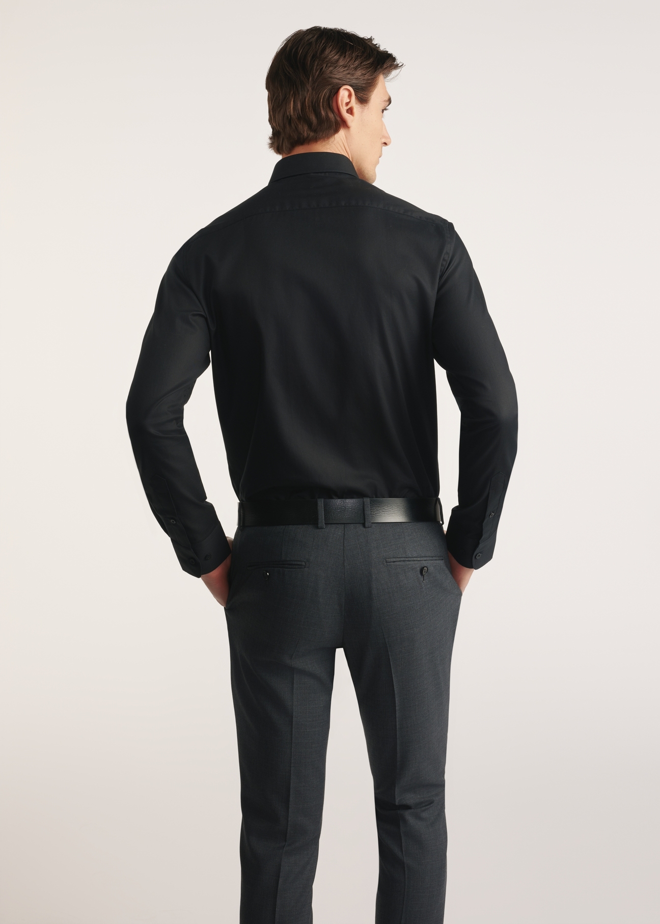 Black men's shirt KOSMT-0351-99(Z25) - product view from the back on the model on a white background. Half of the silhouette visible.