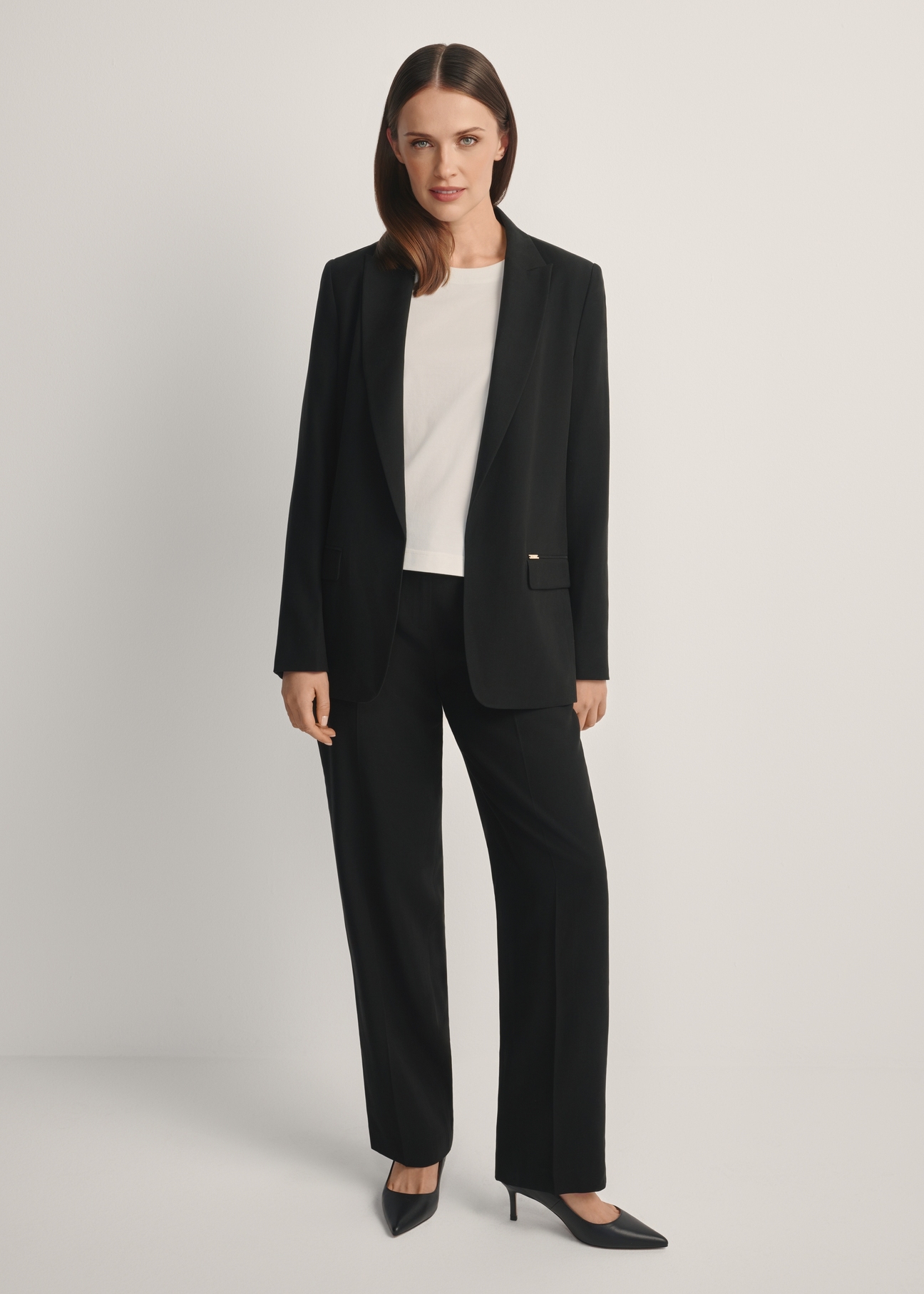 Women's black blazer ZAKDT-0031A-99(W26), front view of the product on the model. Full body visible.