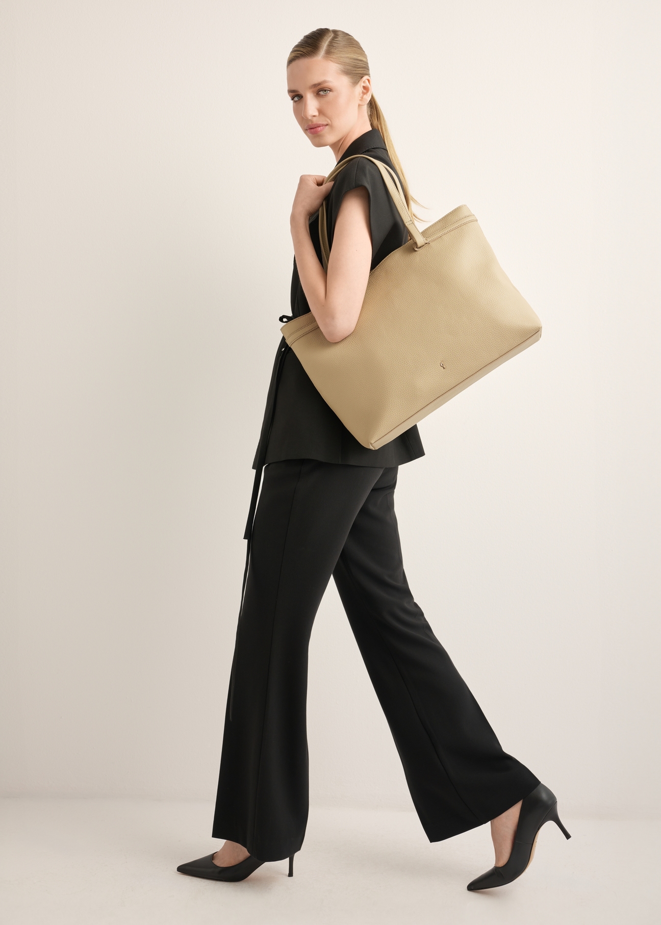 Beige leather women's shoulder bag TORES-1357-1B(Z26), product view on model's shoulder. Full body visible.