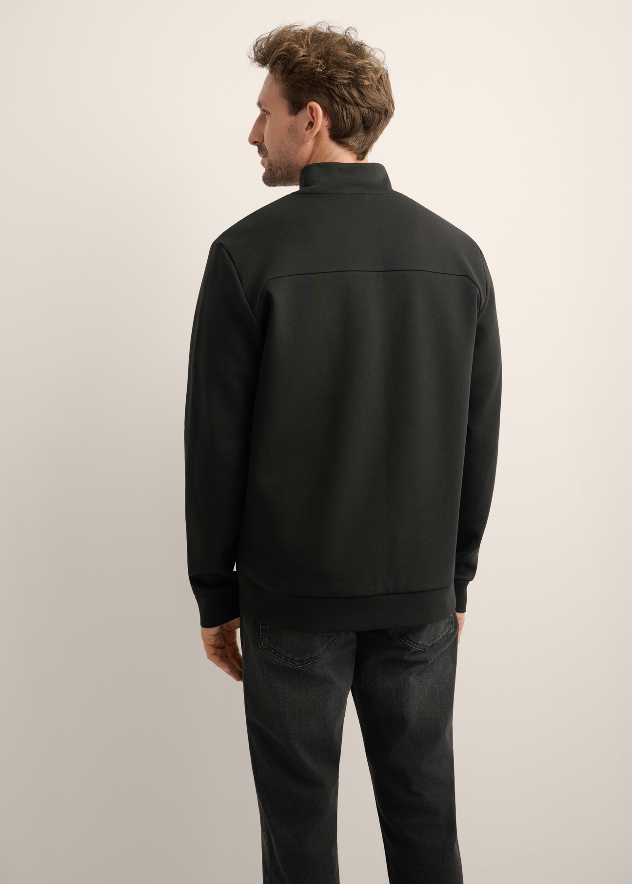 Men's black zip-up sweatshirt with stand-up collar BLZMT-0082-99(Z26), back view of the product on the model. Half of the silhouette visible.