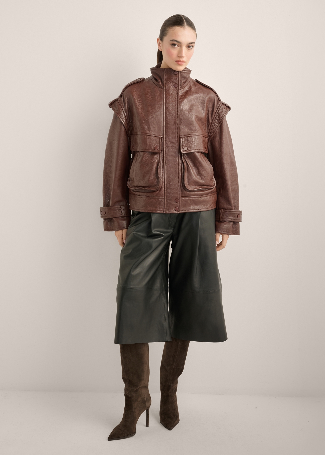 Women's burgundy oversize leather jacket KURDS-0644-4D(Z26), front view of the product on the model. Full body visible.