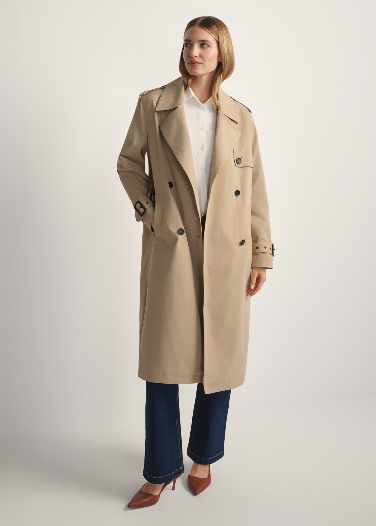 Long beige women's coat KURDT-0512-1C(W26), front view of the product on the model. Full body visible.