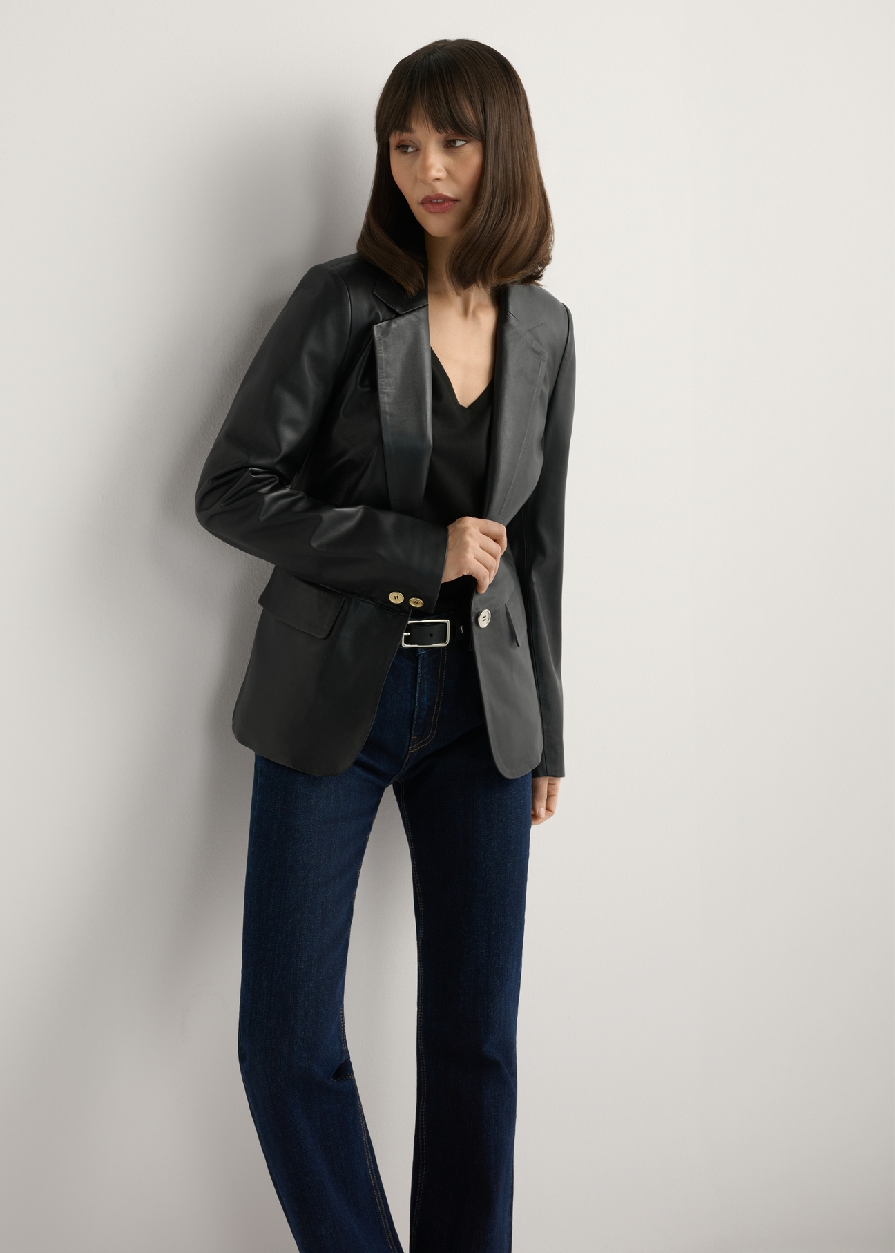 Women's black leather jacket KURDS-0445-99(W26), front view of the product on the model. Half of the silhouette visible.