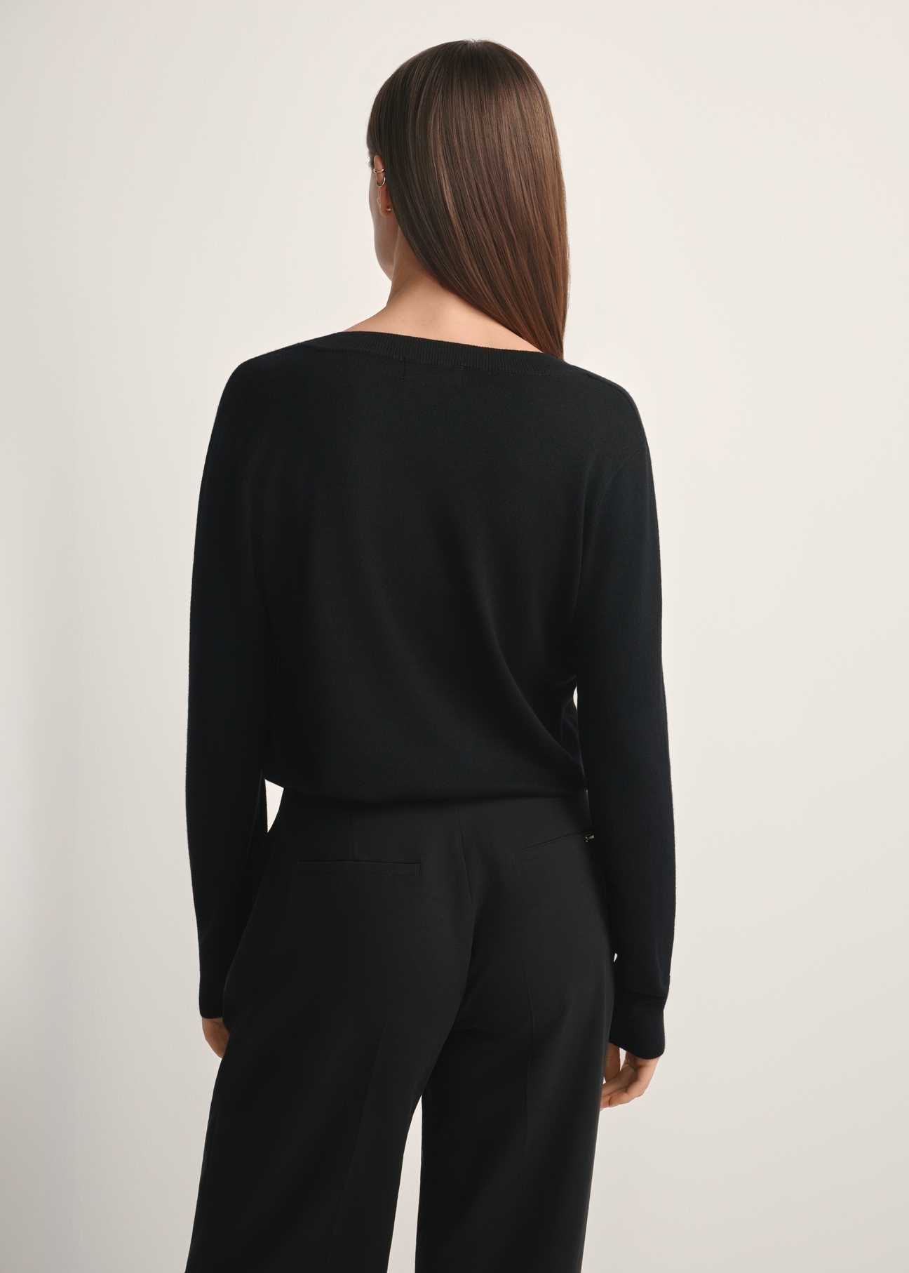 Black V-neck sweater SWEDT-0201-99(W24), product view from the back on the model, half of the silhouette visible.