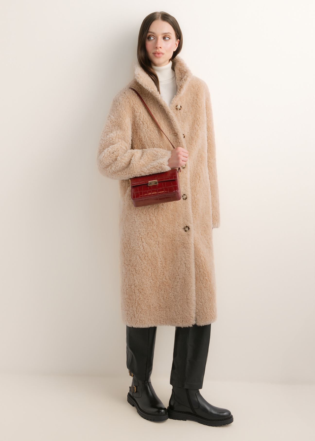 Elegant red women's handbag TOREC-1251-4C(Z26); angled view of the product shown on a model. Full-body view.