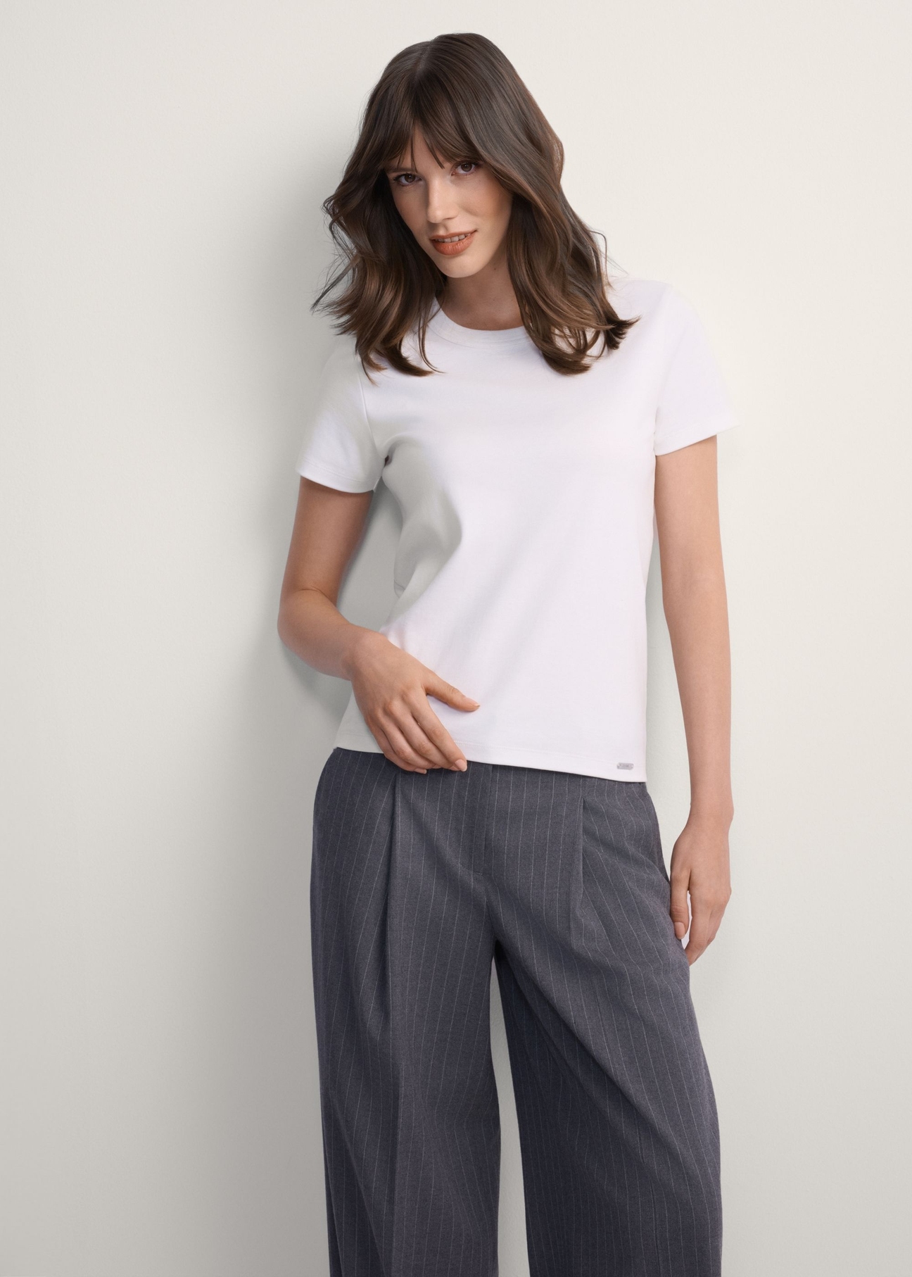 Women's white cotton t-shirt TSHDT-0144-0B(Z26), front view of the product on the model, half of the silhouette visible.