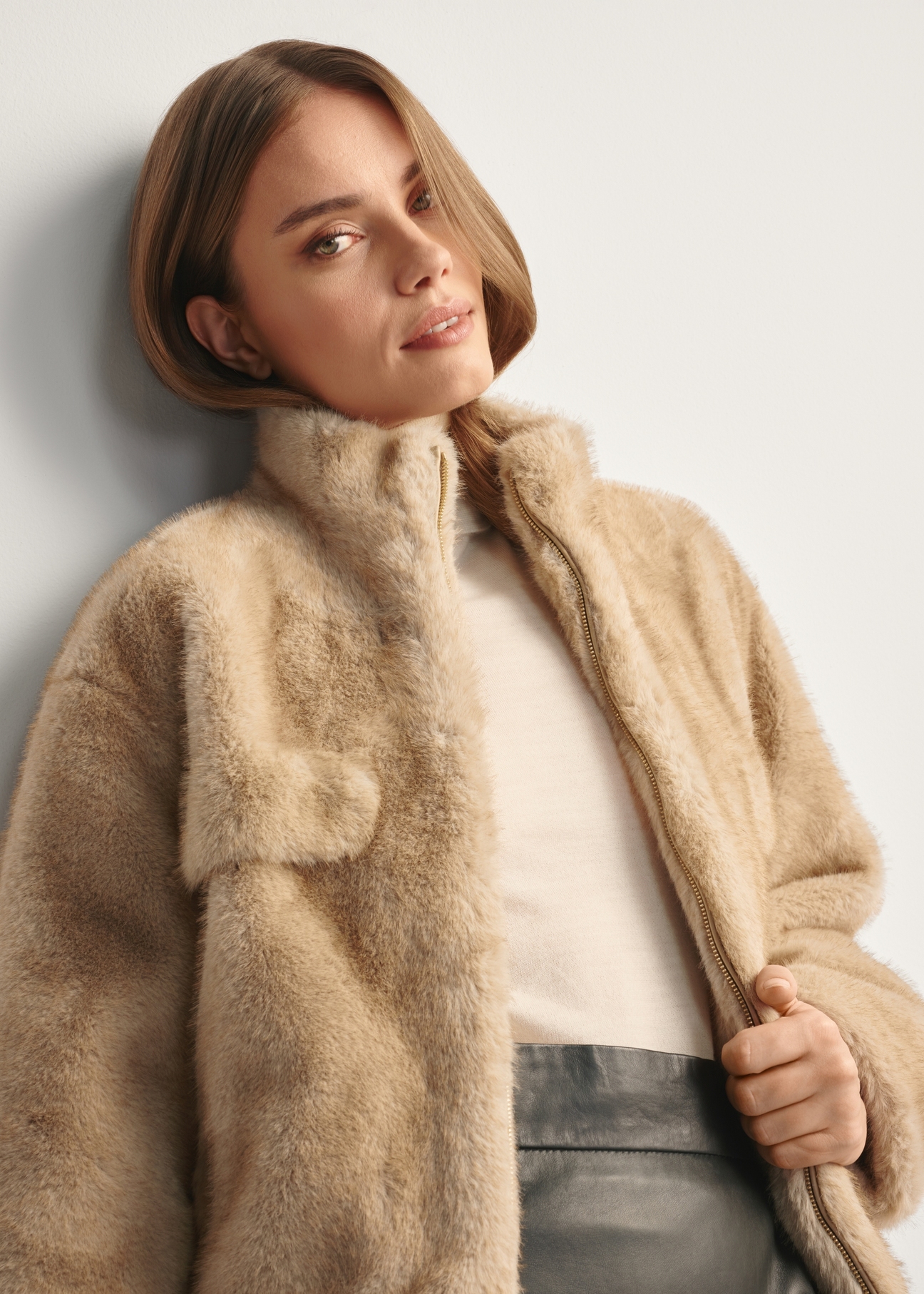 Beige short women's fur coat FUTDP-0071-81(Z25), front view of the product on the model, half of the silhouette visible.
