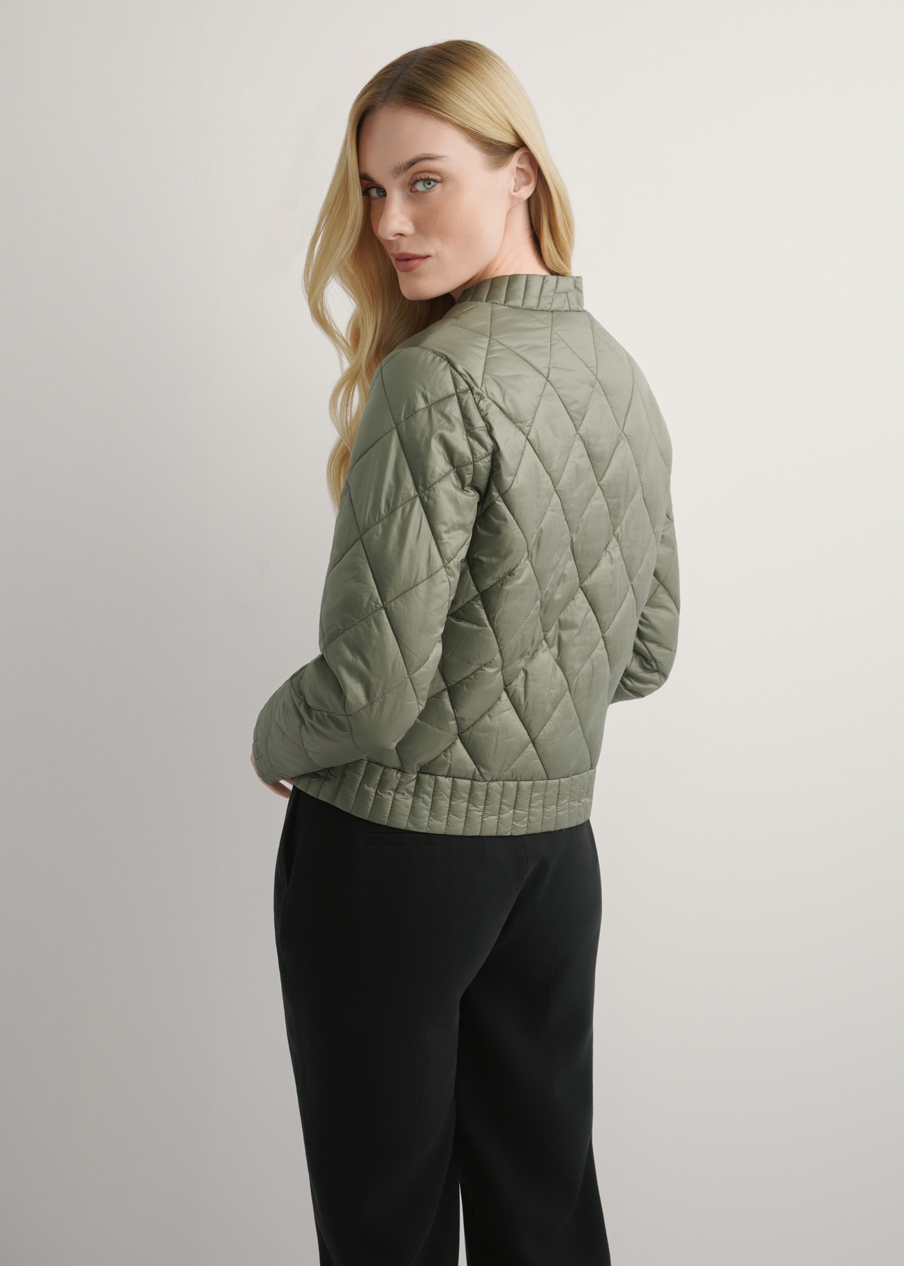 Women's transitional khaki jacket KURDT-0564A-55(W26), back view of the product on the model. Half of the silhouette visible.