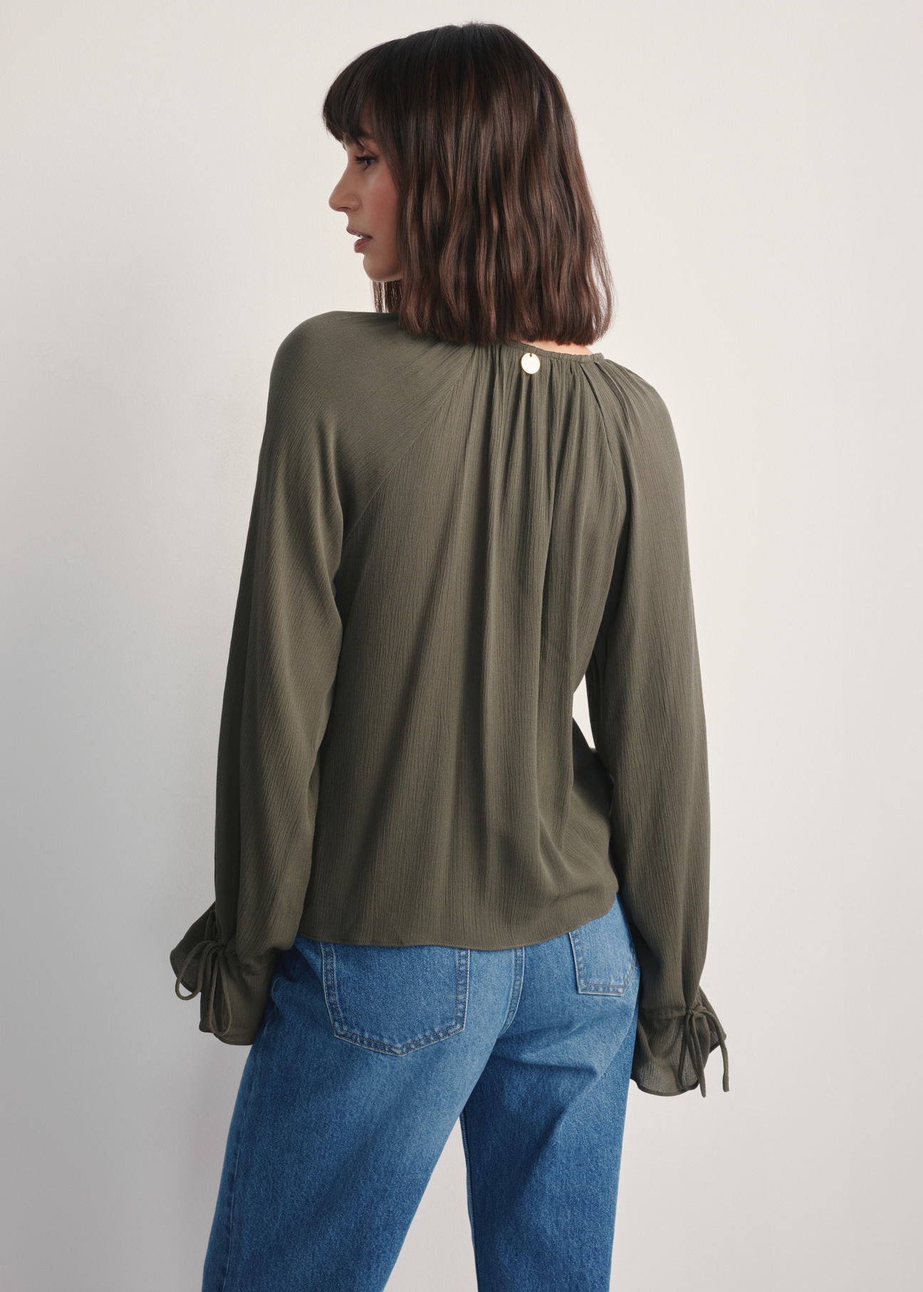 Women's khaki blouse BLUDT-0194-55(Z25), product view from the back on the model, half of the silhouette visible.