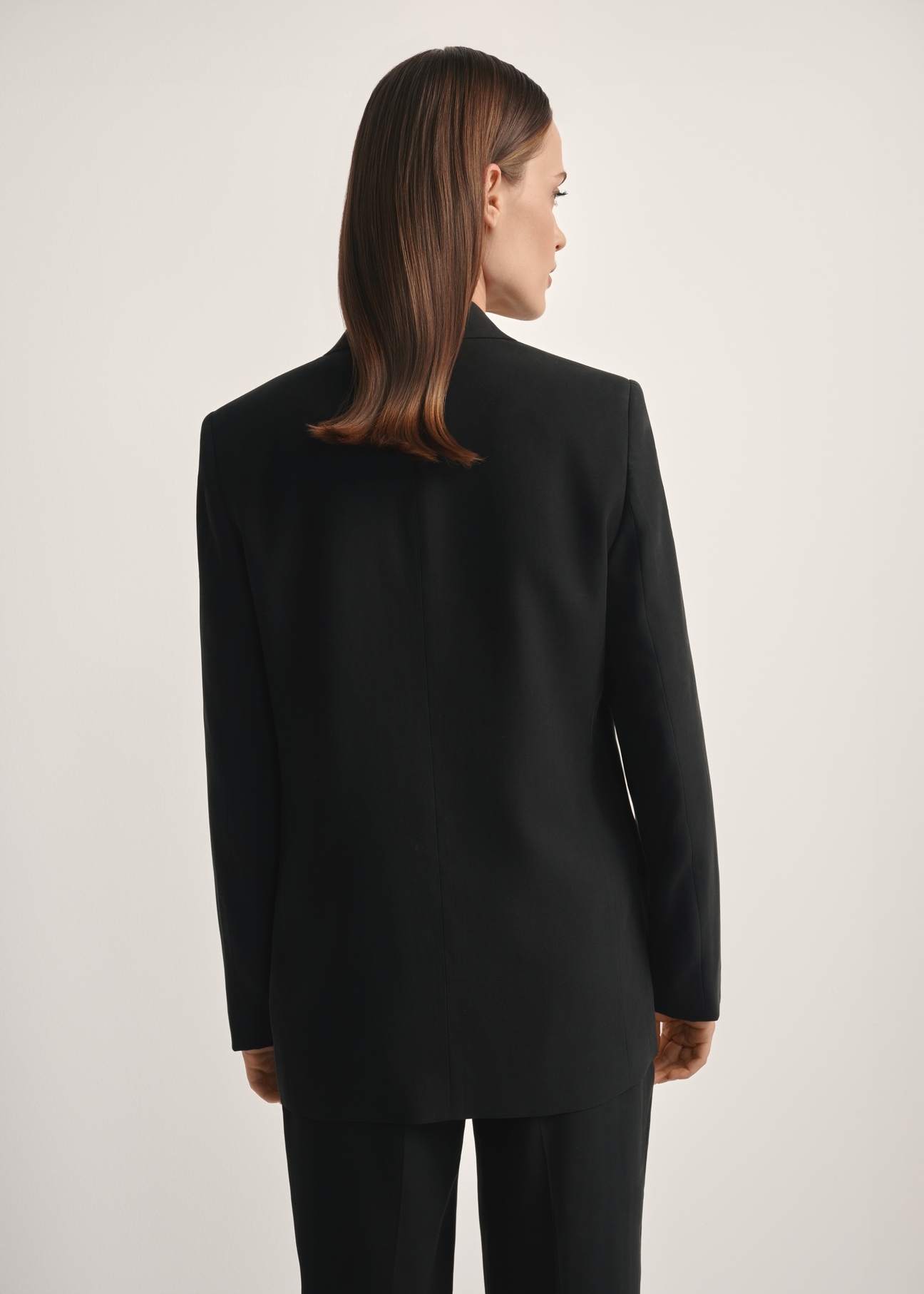 Women's black blazer ZAKDT-0031A-99(W26), back view of the product on the model. Half of the silhouette visible.