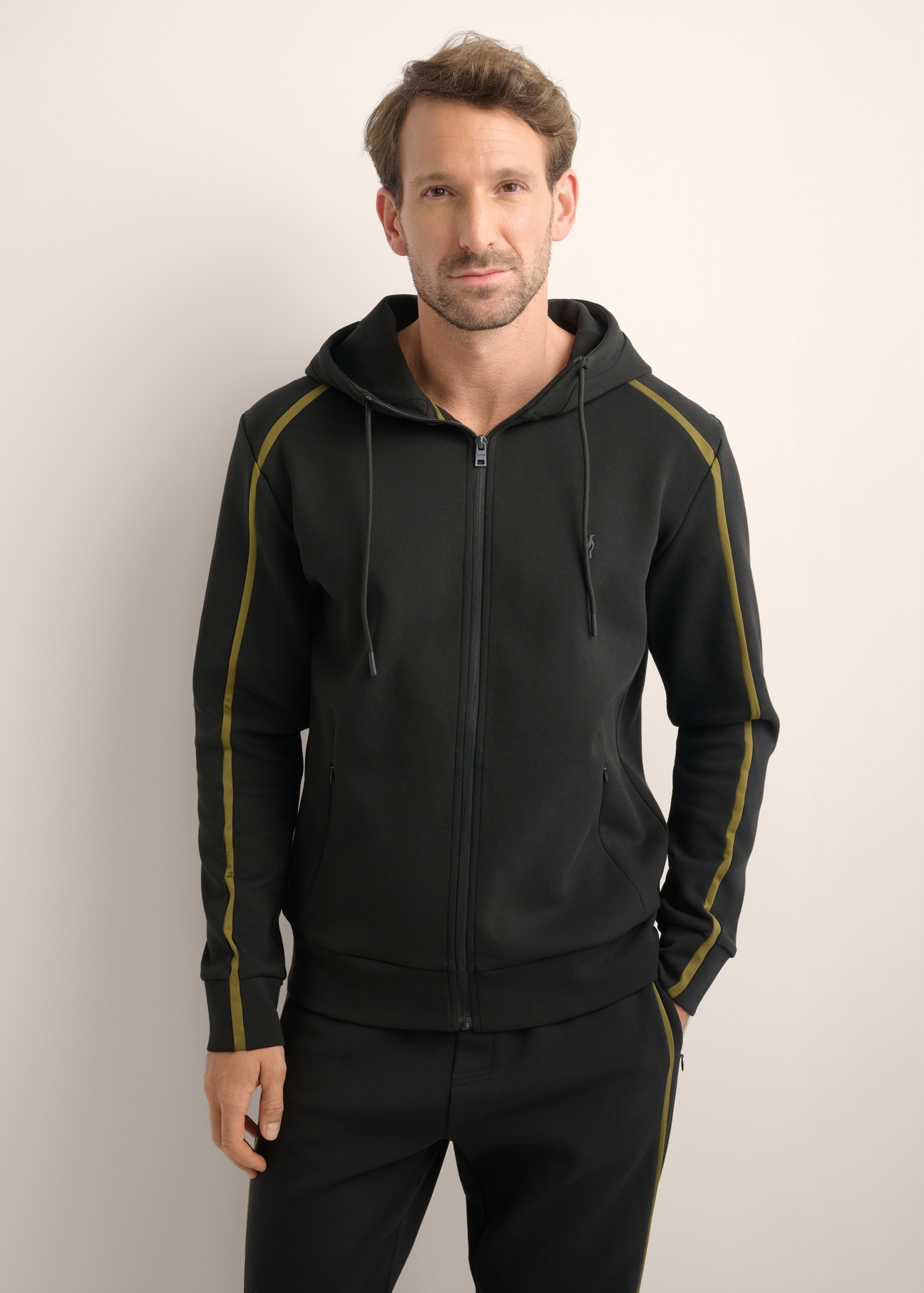 Men's black zip-up hoodie BLZMT-0083-99(Z26), front view of the product on the model. Half of the silhouette visible.