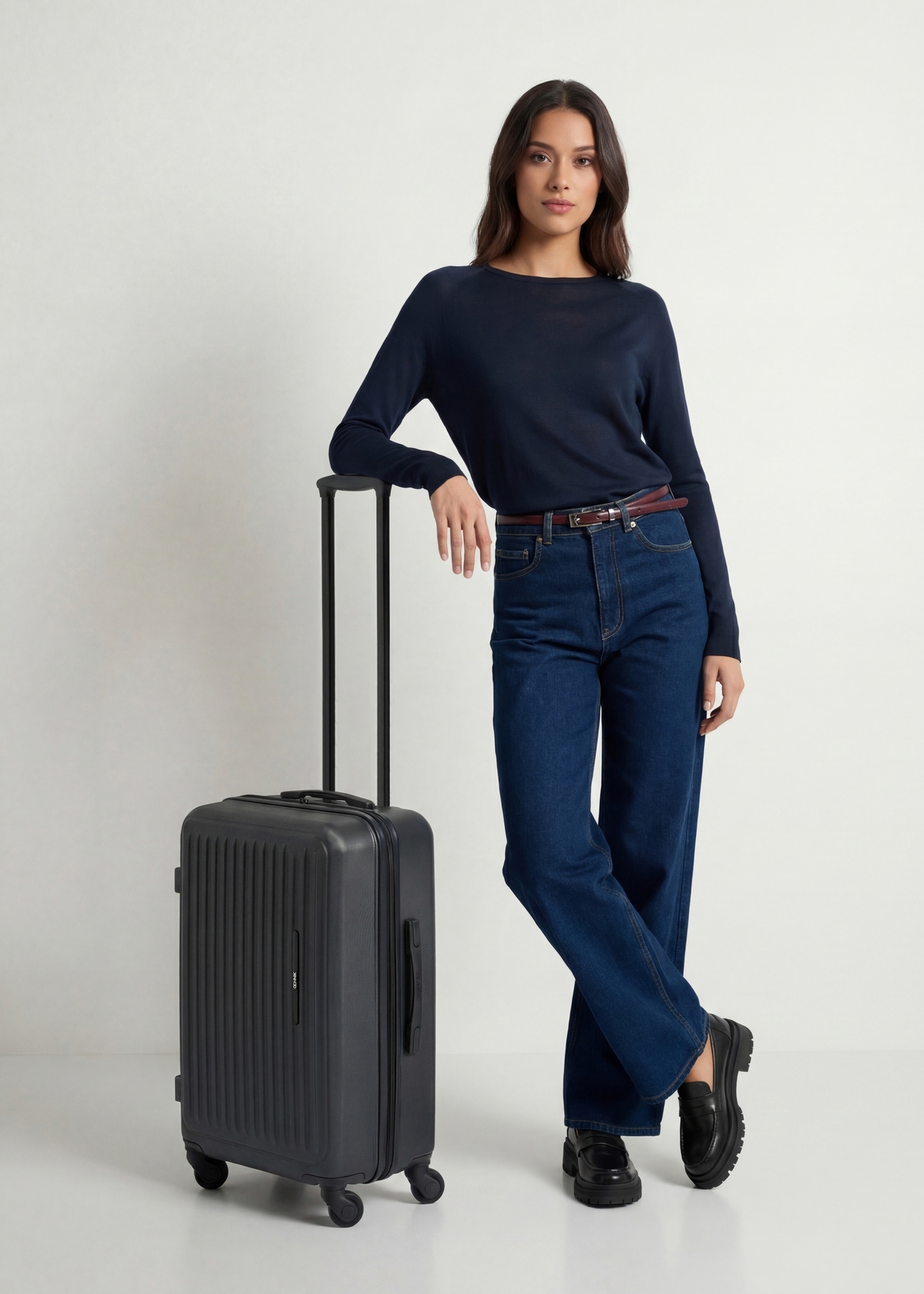 Medium suitcase on wheels WALAB-0082-99-24(W26), diagonal view of the product next to the model's silhouette.