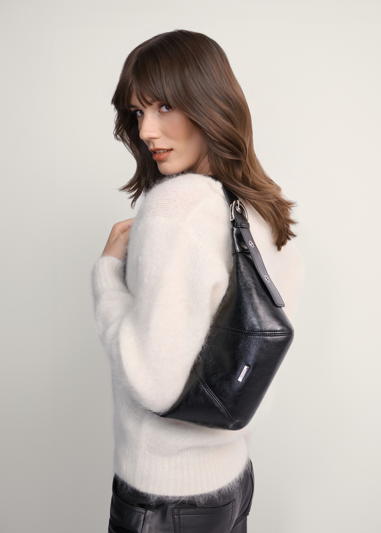 Black small women's waist bag TOREC-1087-99(Z25), front view of the product on a model, half of the silhouette visible.