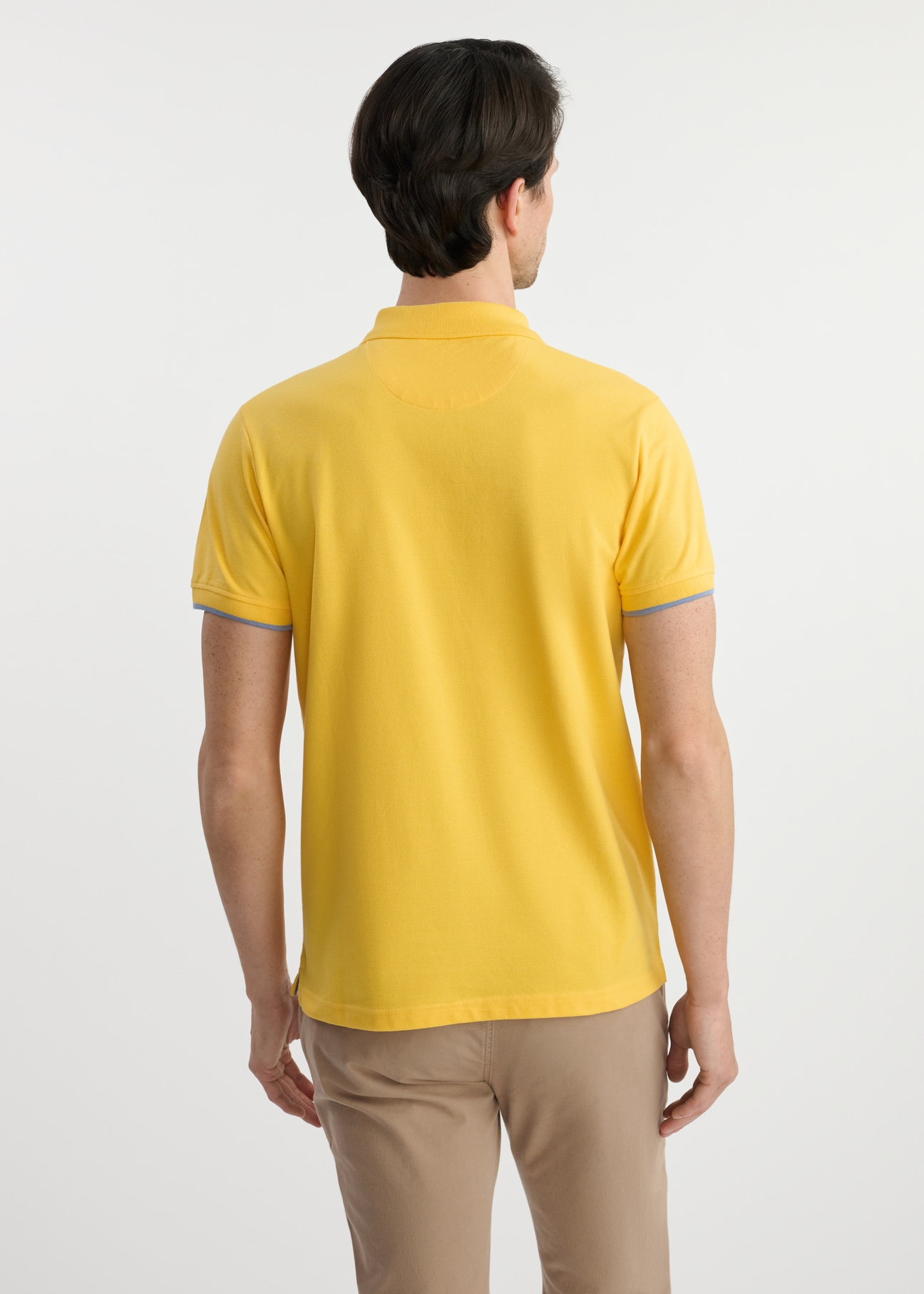 Yellow cotton polo shirt POLMT-0045B-22(W25) - back view on model on white background. Half of the silhouette visible.