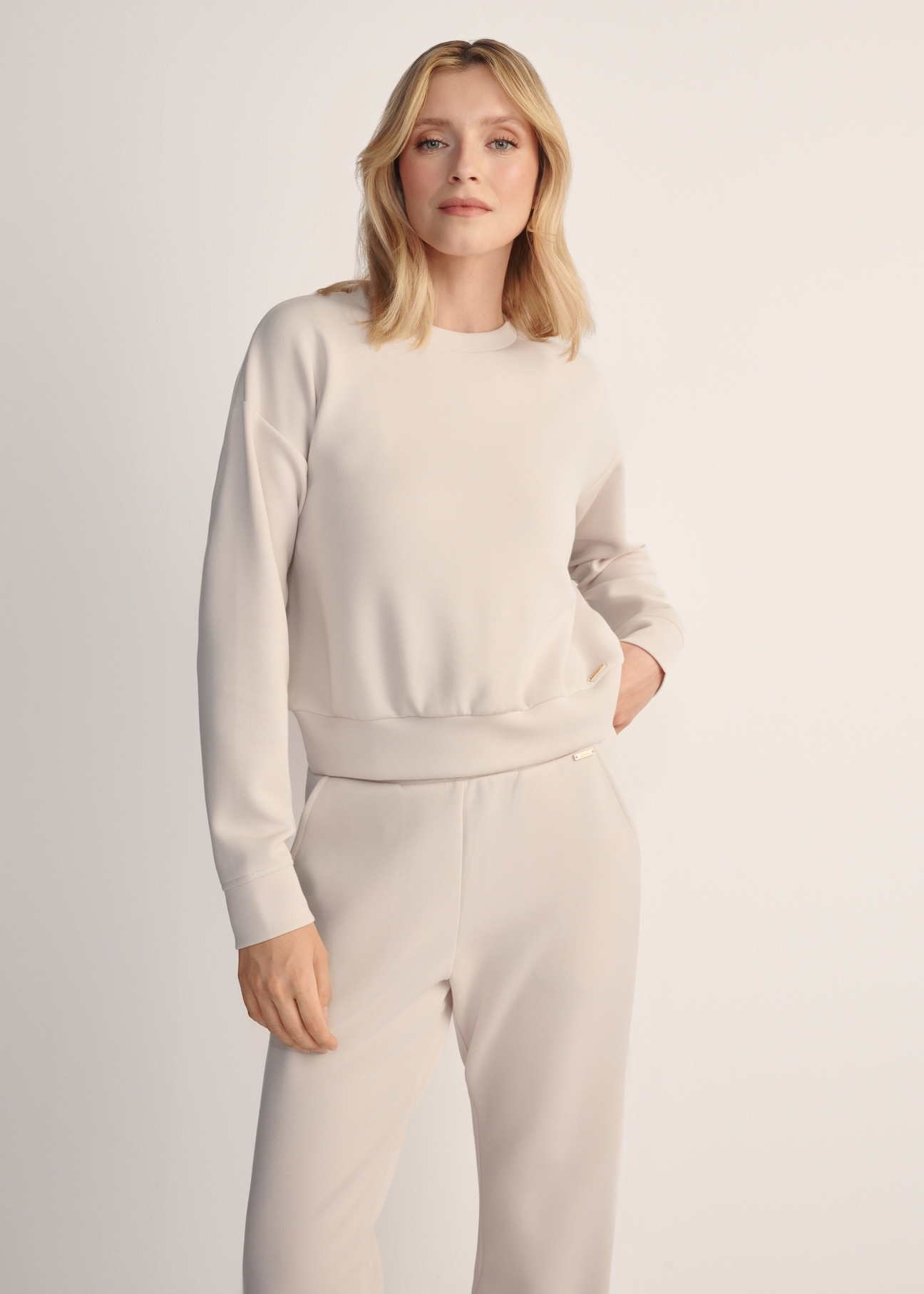 Light beige women's sweatshirt BLZDT-0119-80(Z25), front view of the product on the model. Half of the silhouette visible.