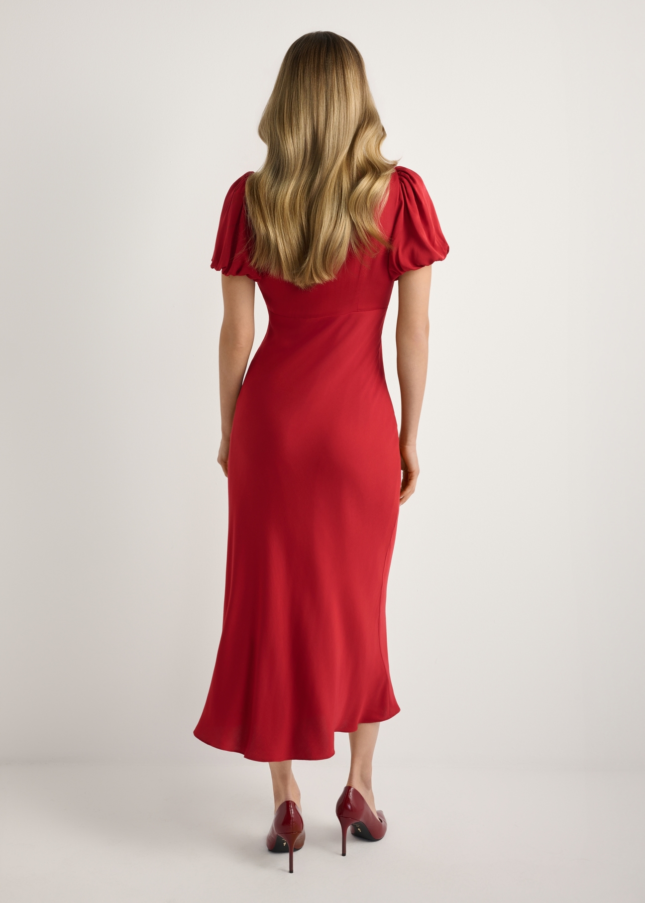 Red long women's dress SUKDT-0262-4B(W26), product view from the back on the model, the whole silhouette is visible.