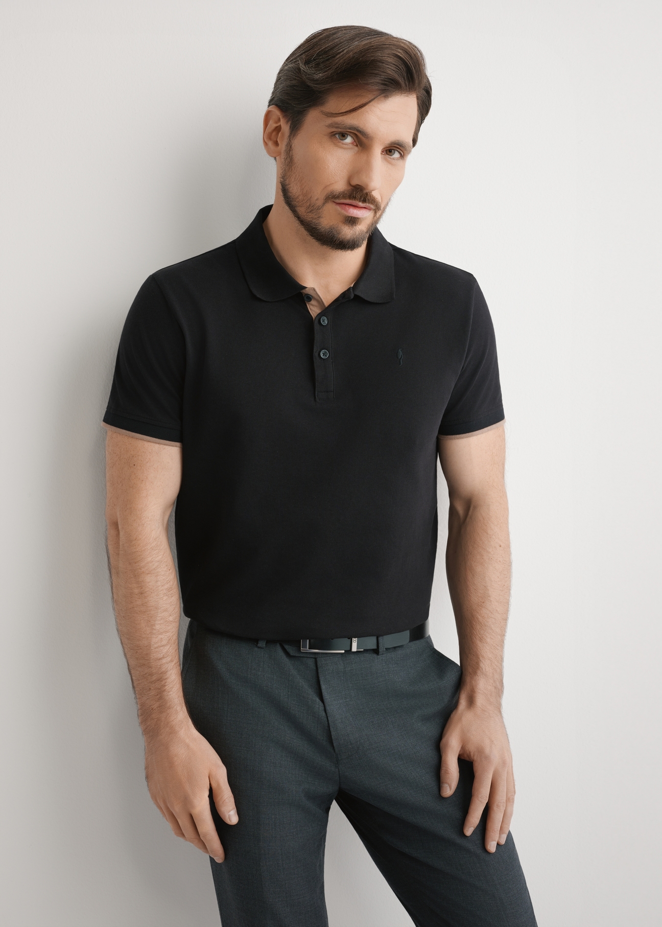 Men's black cotton polo shirt POLMT-0045B-99(W25), front view of the product on the model. Half of the silhouette visible.