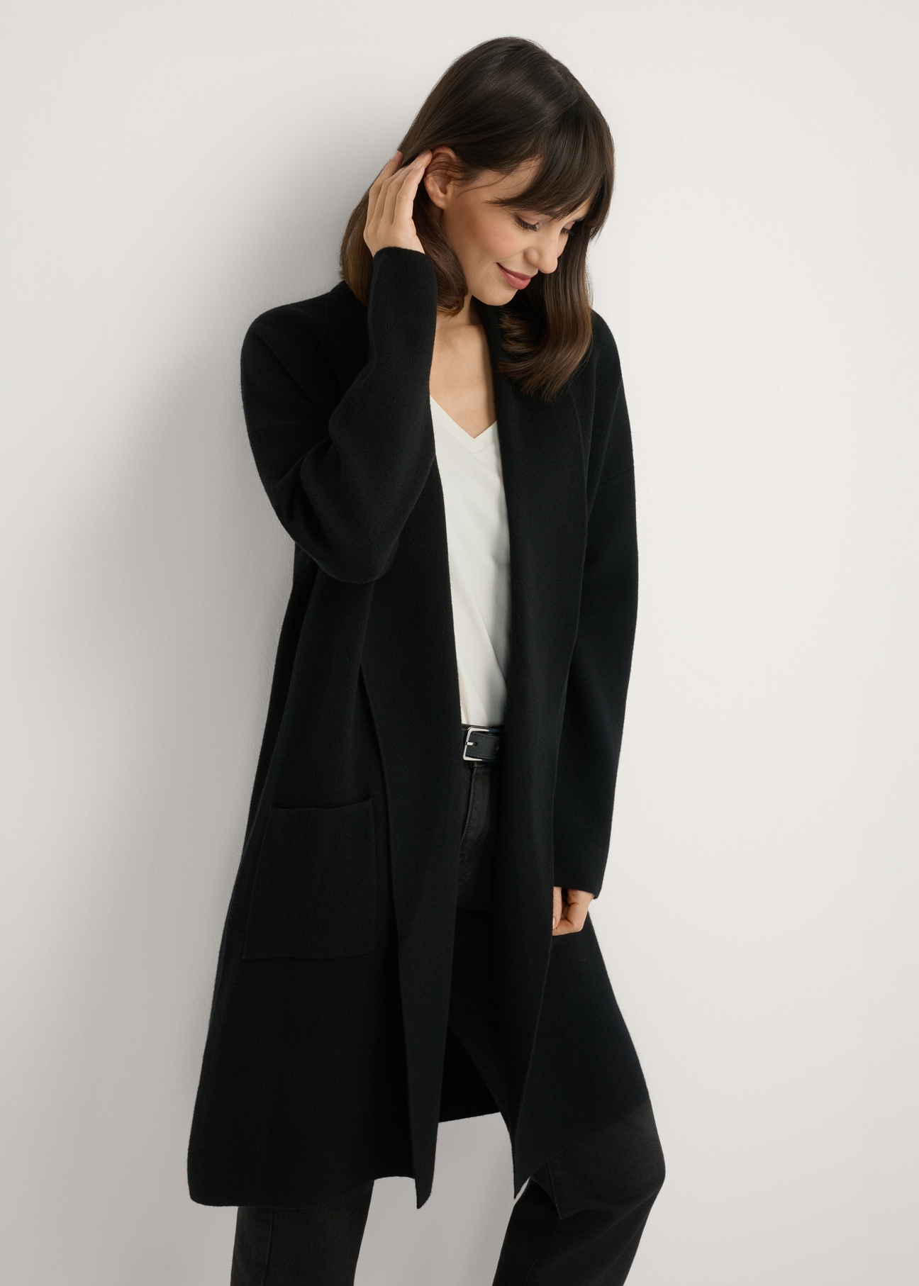 Black basic women's cardigan KARDT-0041-99(W25), front view of the product on the model. Half of the silhouette visible.