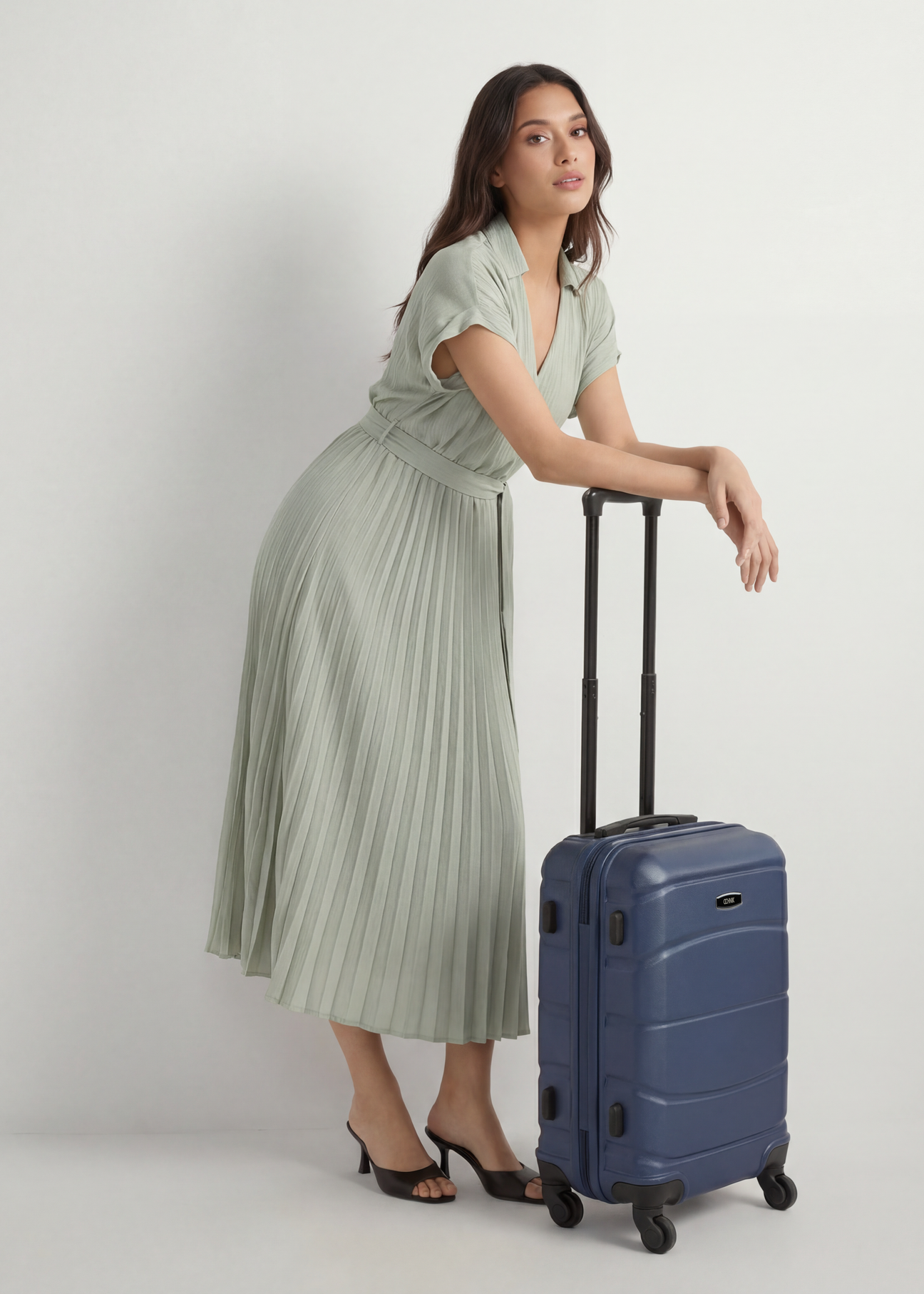 Small suitcase on wheels WALAB-0077-7D-19(W26), product view from the front next to the model, the whole silhouette is visible.