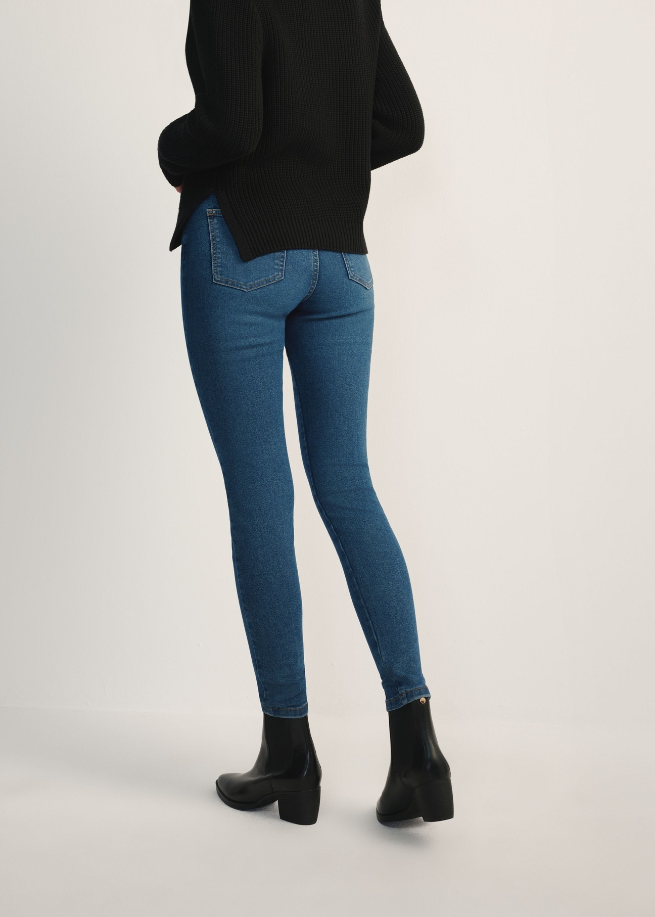 Blue women's denim pants JEADT-0010A-7B(Z26) - product view from the back on the model, half of the silhouette visible.
