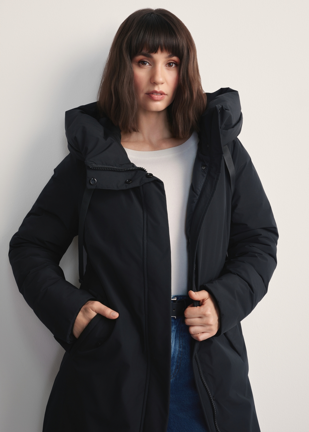 Black women's winter jacket KURDT-0583-99(Z25), front view of the product on a model. Half of the silhouette visible.