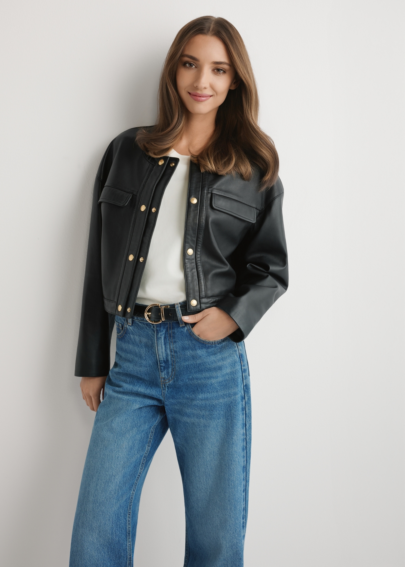 Women's short black leather jacket KURDS-0597-99(W26), front view of the product on the model. Half of the silhouette visible.