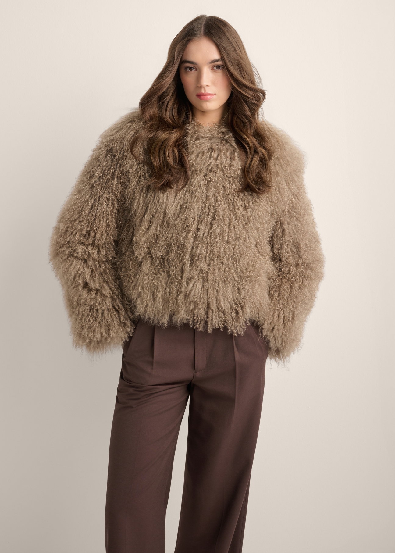 Brown short natural fur coat FUTDF-0104-1K(Z26), front view of the product on a model. Half of the silhouette visible.