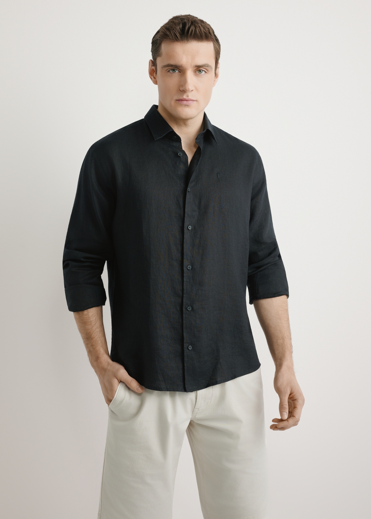 Men's black linen shirt KOSMT-0321A-99(W26) - front view of the product, on a model, against a light background. Half of the silhouette visible.
