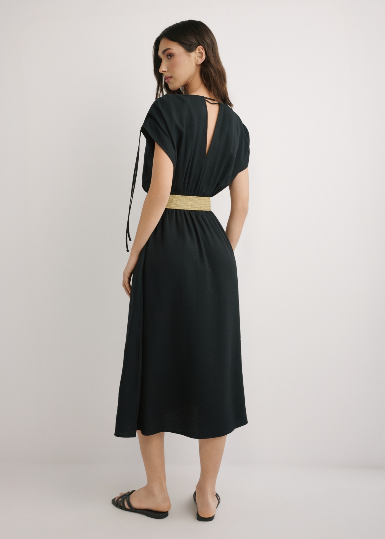 Black long dress with short sleeves SUKDT-0225-99(W26), back view of the product on the model. Full body visible.
