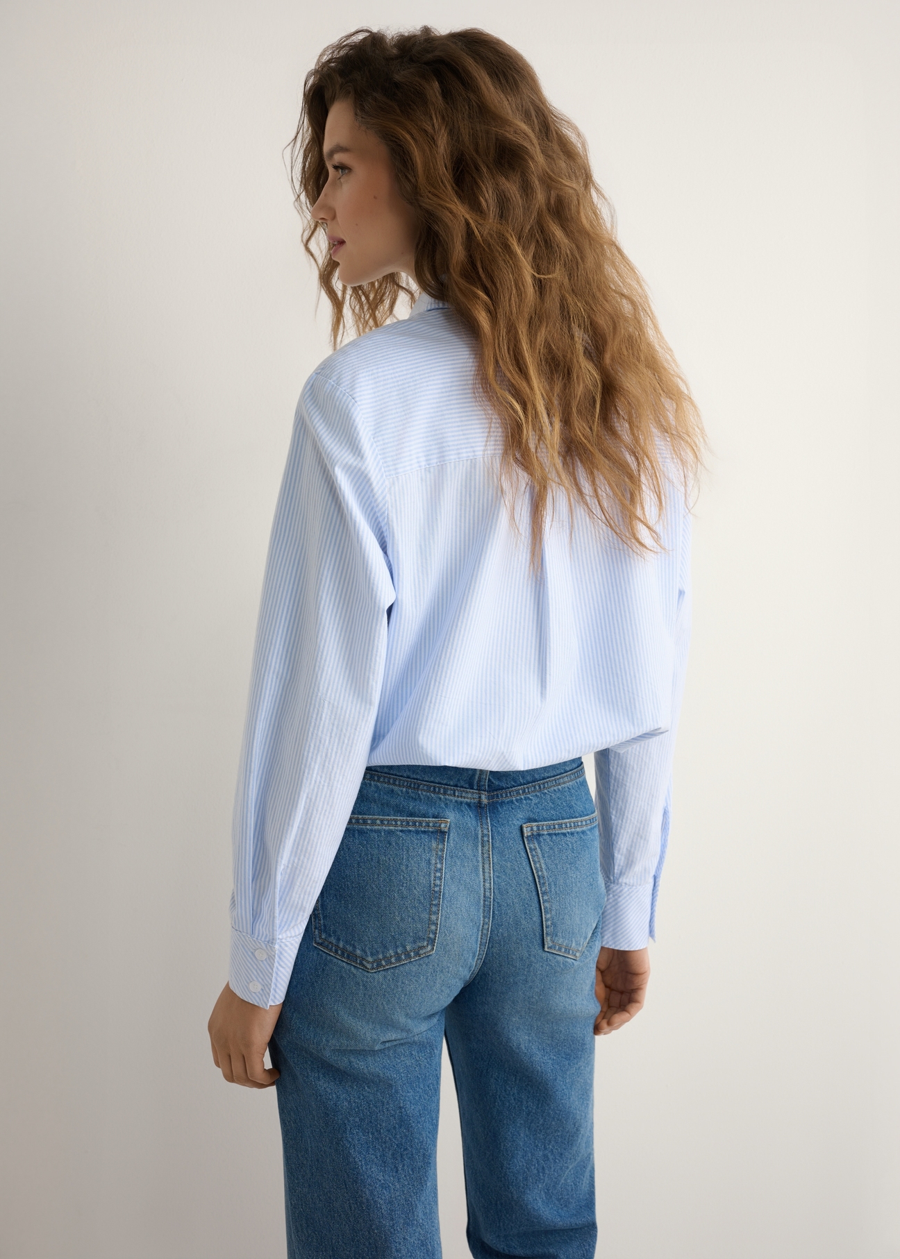 Women's striped cotton shirt KOSDT-0184-7A(W26), back view of the product on the model. Half of the silhouette visible.